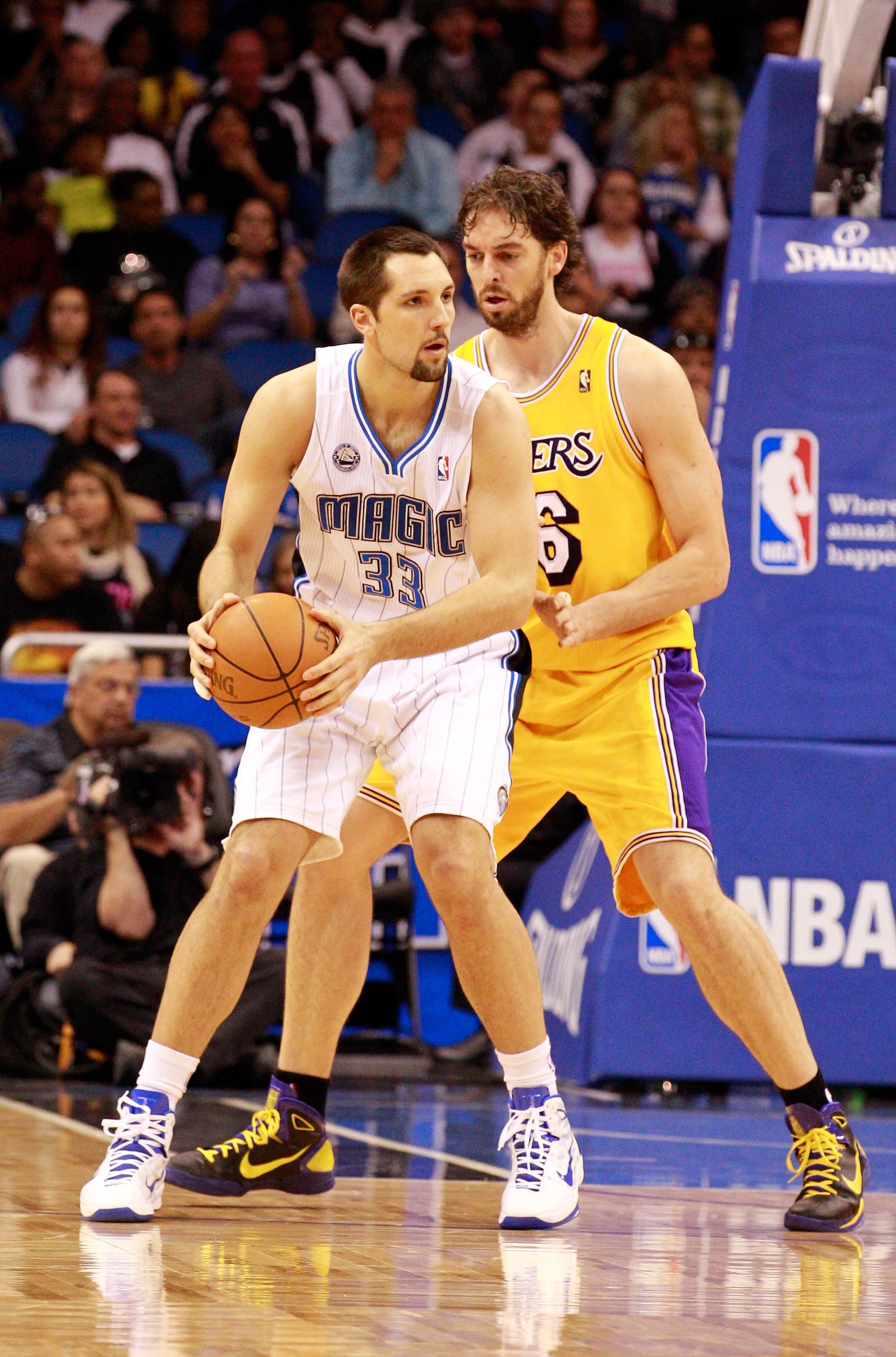 ORLANDO, FL - FEBRUARY 13:  Ryan Anderson #33 of the Orlando Magic is guarded by Pau Gasol #6 of the Los Angeles Lakers during the game at Amway Arena on February 13, 2011 in Orlando, Florida.  NOTE TO USER: User expressly acknowledges and agrees that, by