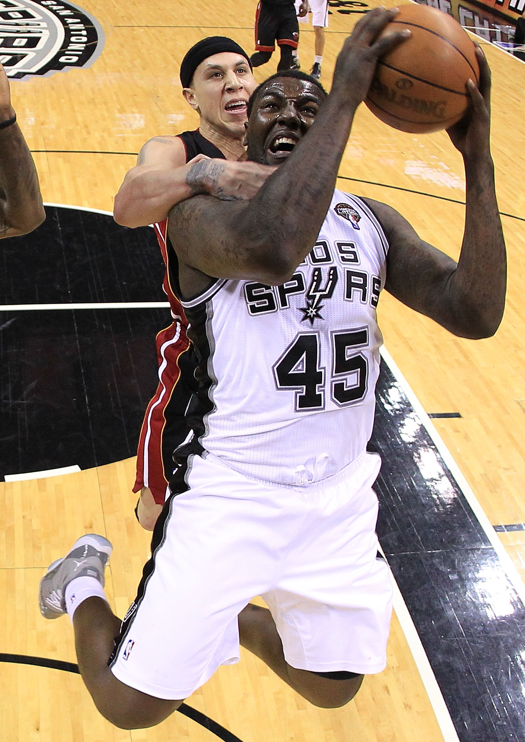 SAN ANTONIO, TX - MARCH 04:  Forward DeJuan Blair #45 of the San Antonio Spurs takes a shot against Mike Bibby #0 of the Miami Heat at AT&T Center on March 4, 2011 in San Antonio, Texas.   NOTE TO USER: User expressly acknowledges and agrees that, by down