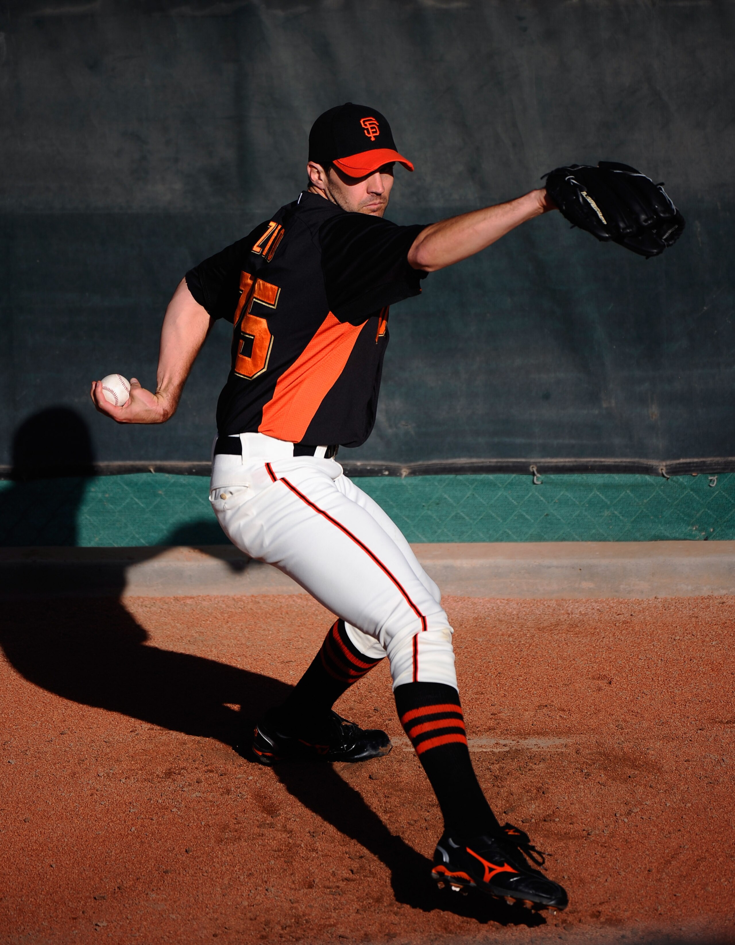 SCOTTSDALE, AZ - MARCH 07:  Pitcher Barry Zito #75 of the San Francisco Giants thorws a pitch in the bullpen prior to the start of the spring training baseball game against the Texas Rangers in the first meeting between the two teams since the World Serie