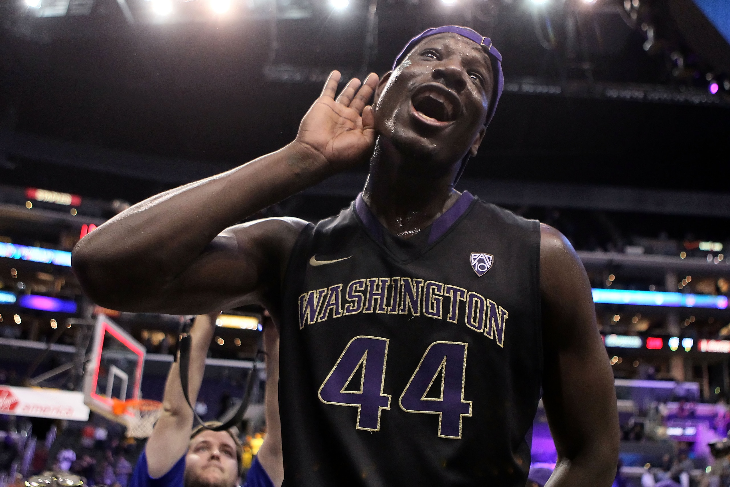 LOS ANGELES, CA - MARCH 12:  Darnell Gant #44 of the Washington Huskies celebrates after defeating the Arizona Wildcats 77-75  in overtime in the championship game of the 2011 Pacific Life Pac-10 Men's Basketball Tournament at Staples Center on March 12,