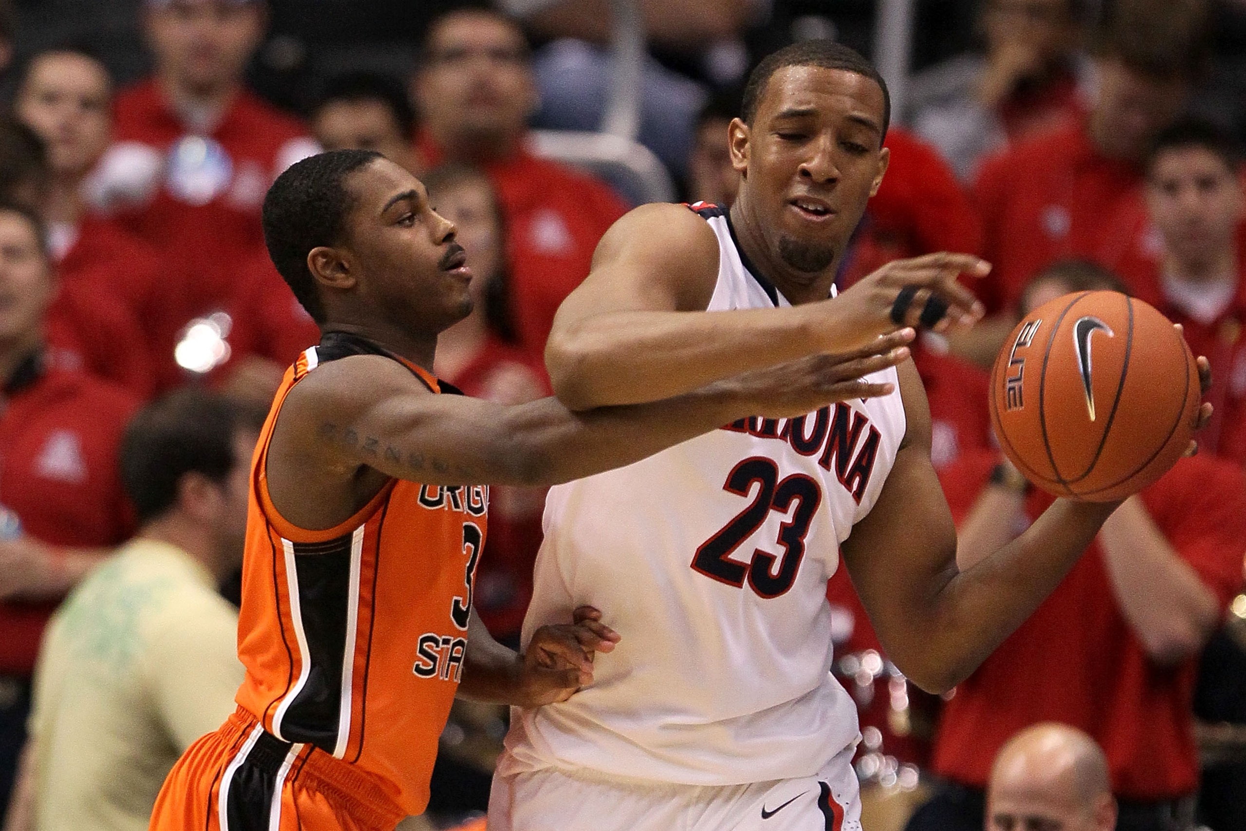 LOS ANGELES, CA - MARCH 10:  Derrick Williams #23 of the Arizona Wildcats has the ball against Ahmad Starks #3 of the Oregon State Beavers in the second half in the quarterfinals of the 2011 Pacific Life Pac-10 Men's Basketball Tournament at Staples Cente