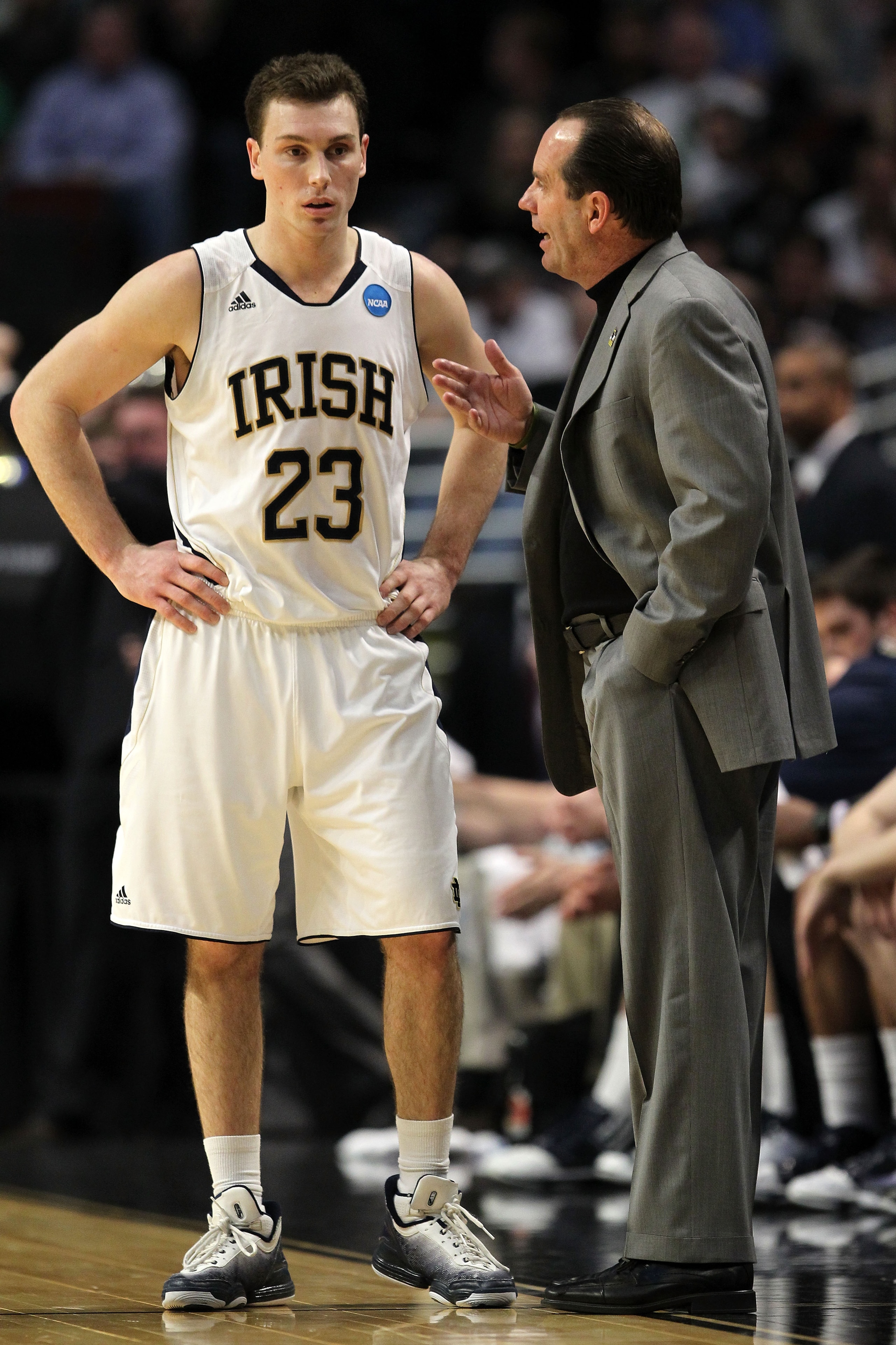 CHICAGO, IL - MARCH 18:  Head coach Mike Brey of the Notre Dame Fighting Irish talks with Ben Hansbrough #23 in the first half of the game against the Akron Zips during the second round of the 2011 NCAA men's basketball tournament at the United Center on