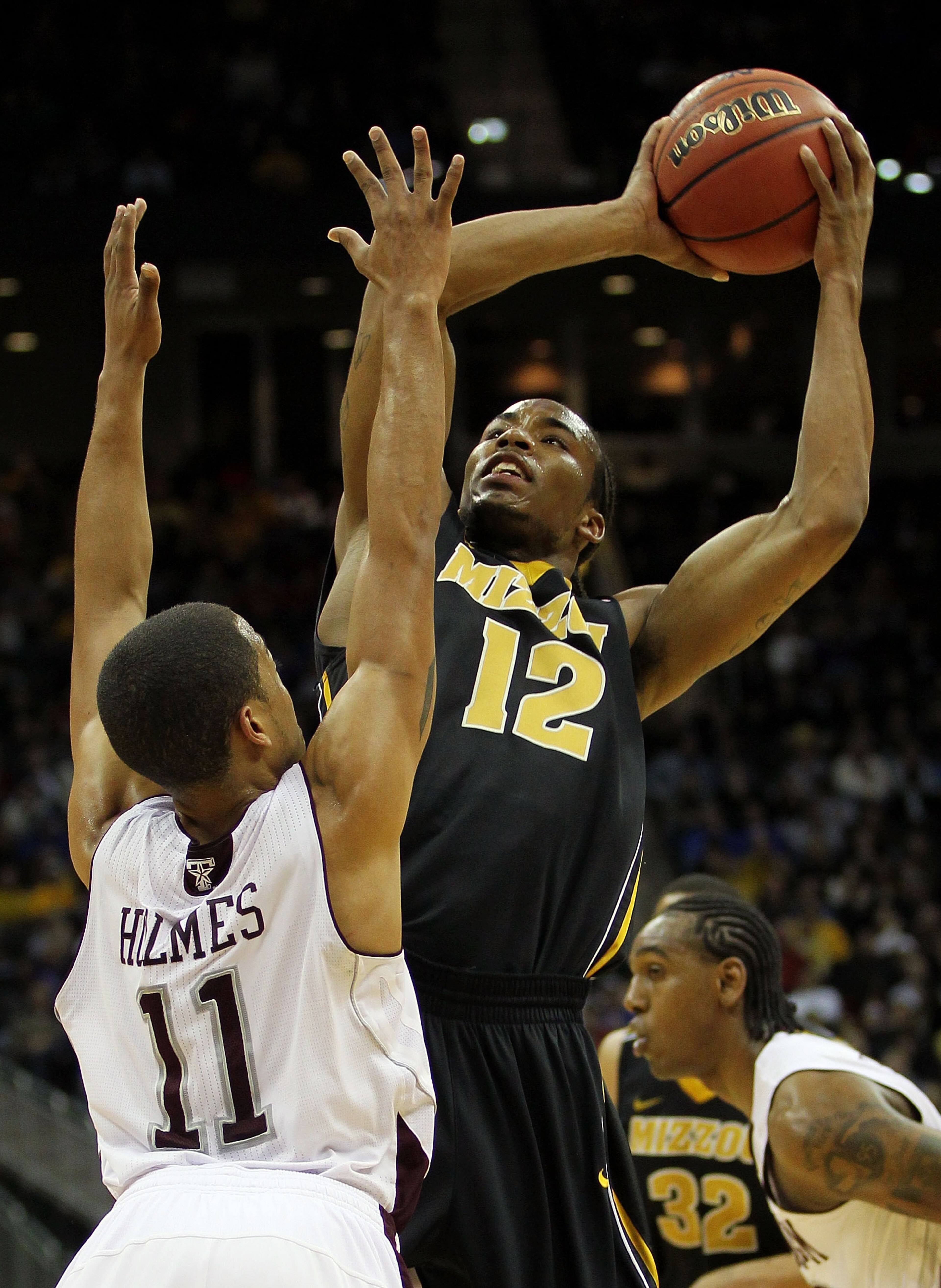 KANSAS CITY, MO - MARCH 10:  Marcus Denmon #12 of the Missouri Tigers goes up for a shot against B.J. Holmes #11 of the Texas A&M Aggies during their quarterfinal game in the 2011 Phillips 66 Big 12 Men's Basketball Tournament at Sprint Center on March 10