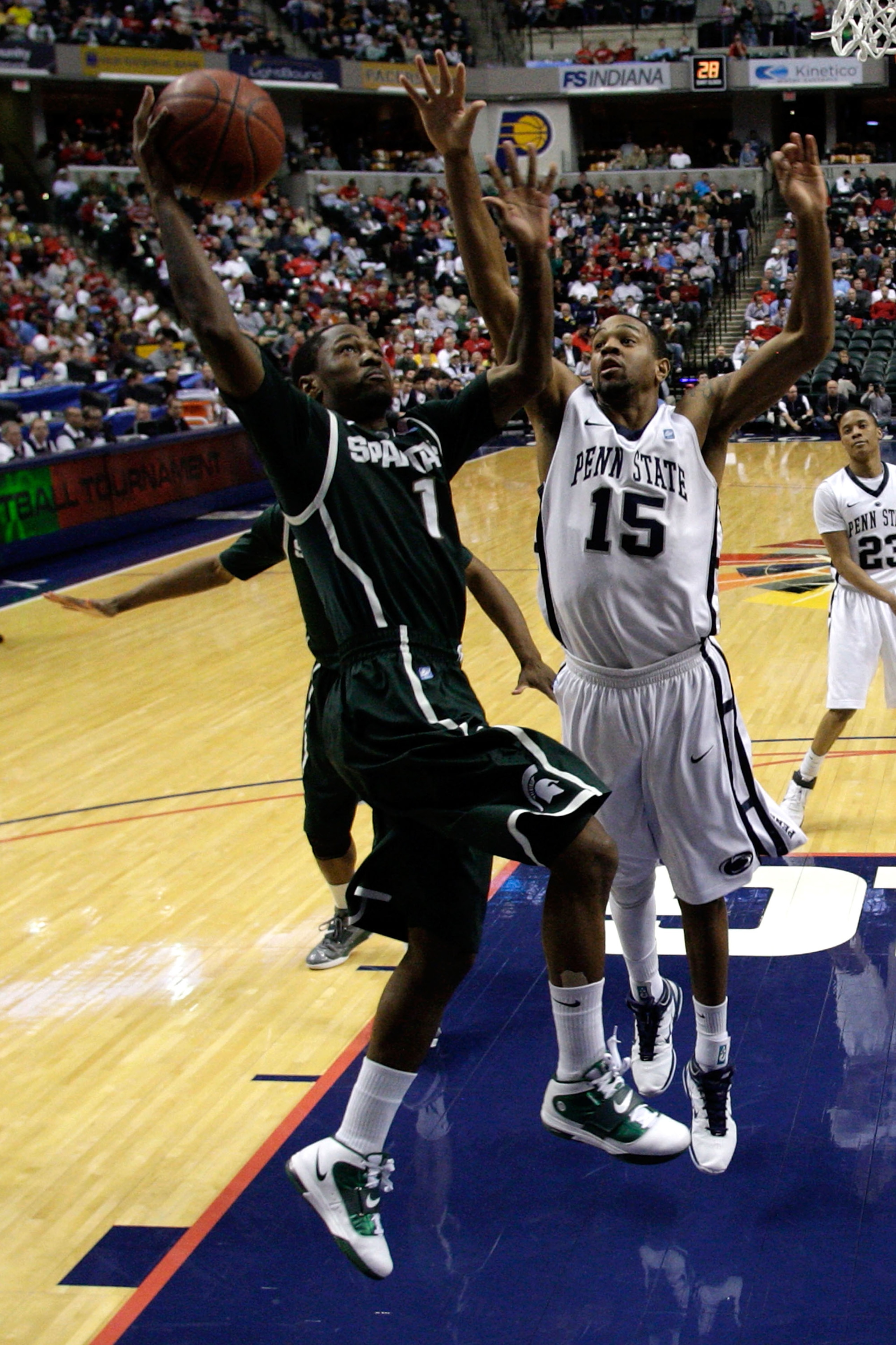 INDIANAPOLIS, IN - MARCH 12:  Kalin Lucas #1 of the Michigan State Spartans drives for a shot attempt against David Jackson #15 of the Penn State Nittany Lions during the semifinals of the 2011 Big Ten Men's Basketball Tournament at Conseco Fieldhouse on