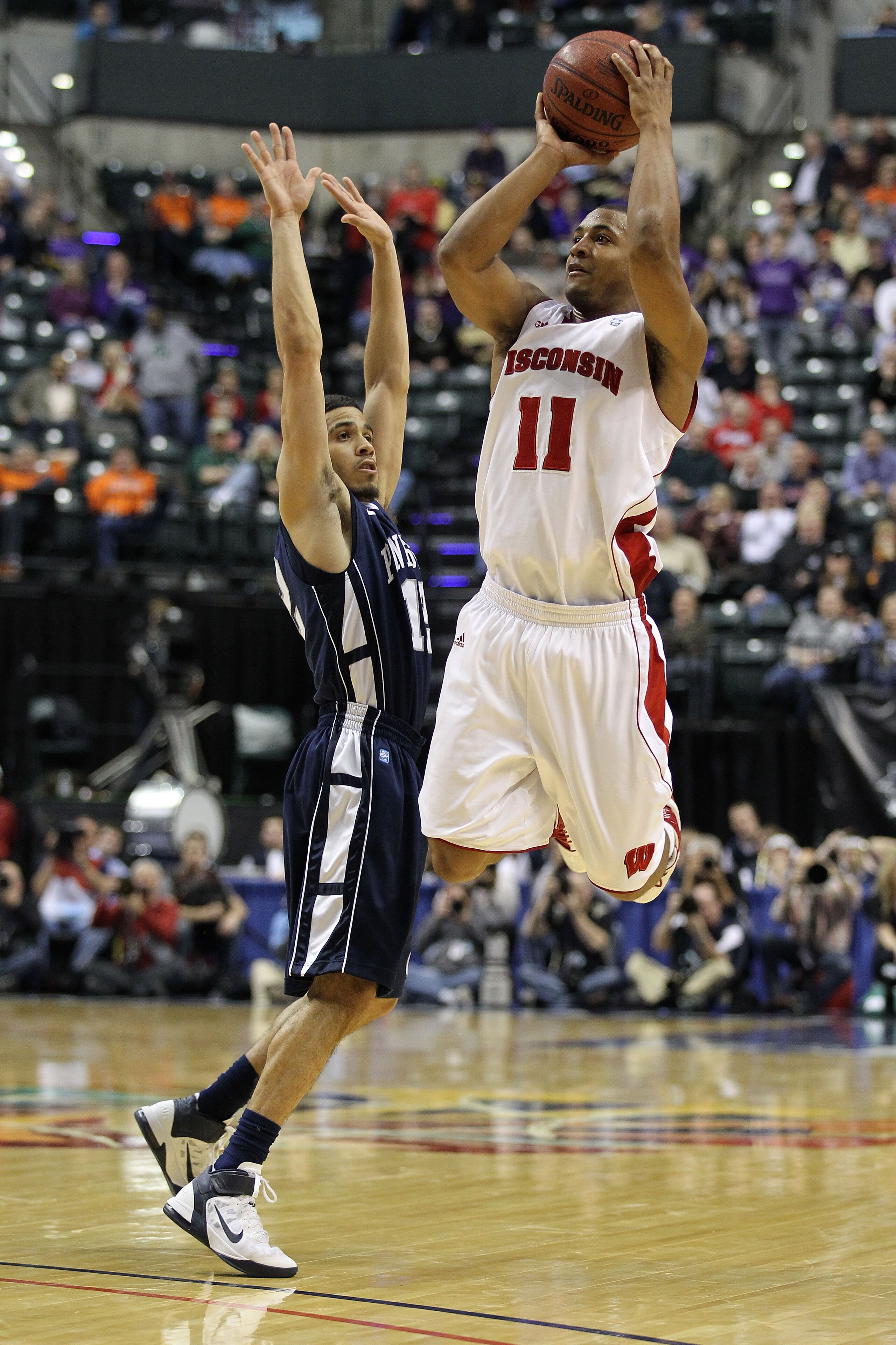 INDIANAPOLIS, IN - MARCH 11:  Jordan Taylor #11 of the Wisconsin Badgers attempts a shot against Talor Battle #12 of the Penn State Nittany Lions during the quarterfinals of the 2011 Big Ten Men's Basketball Tournament at Conseco Fieldhouse on March 11, 2