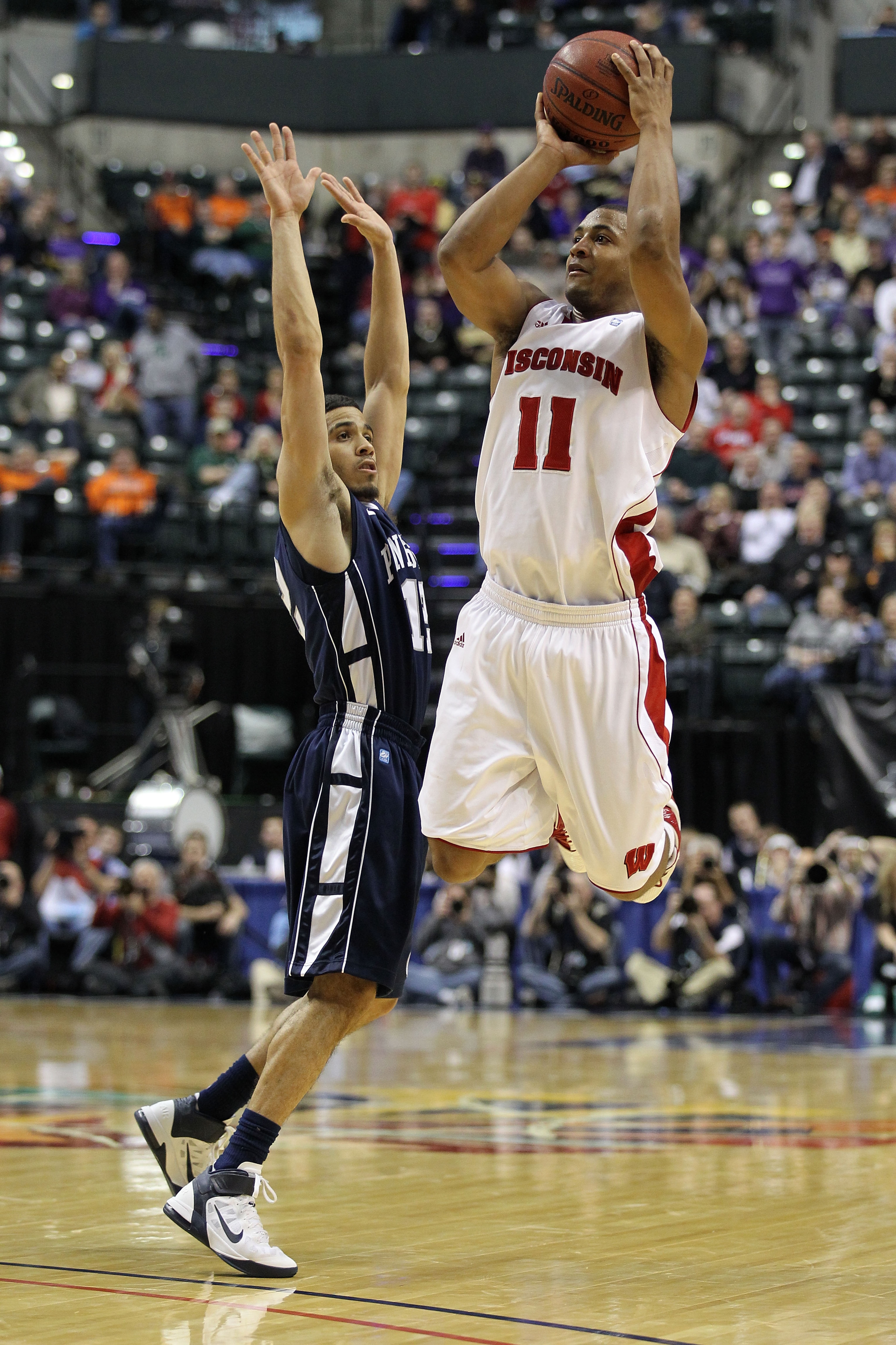 INDIANAPOLIS, IN - MARCH 11:  Jordan Taylor #11 of the Wisconsin Badgers attempts a shot against Talor Battle #12 of the Penn State Nittany Lions during the quarterfinals of the 2011 Big Ten Men's Basketball Tournament at Conseco Fieldhouse on March 11, 2