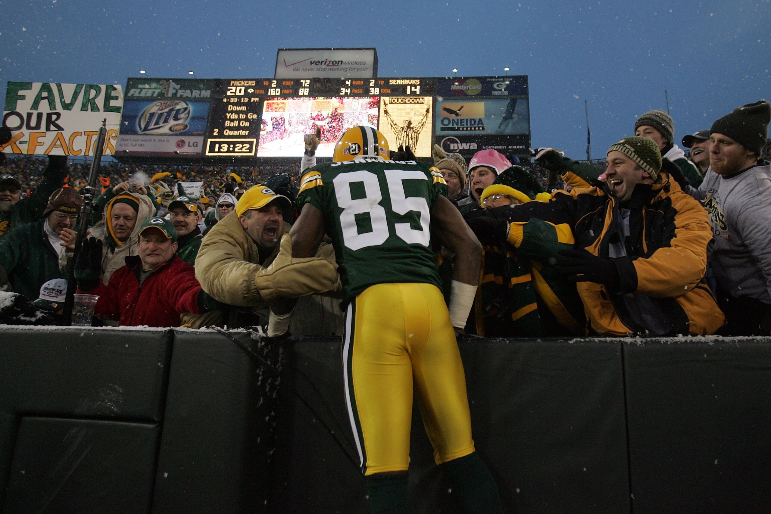 GREEN BAY, WI - JANUARY 12:  Wide receiver Greg Jennings #85 of the Green Bay Packers celebrates with a 'Lambeau leap' after catching a two-yard touchdown pass in the second quarter against the Seattle Seahawks during the NFC divisional playoff game on Ja