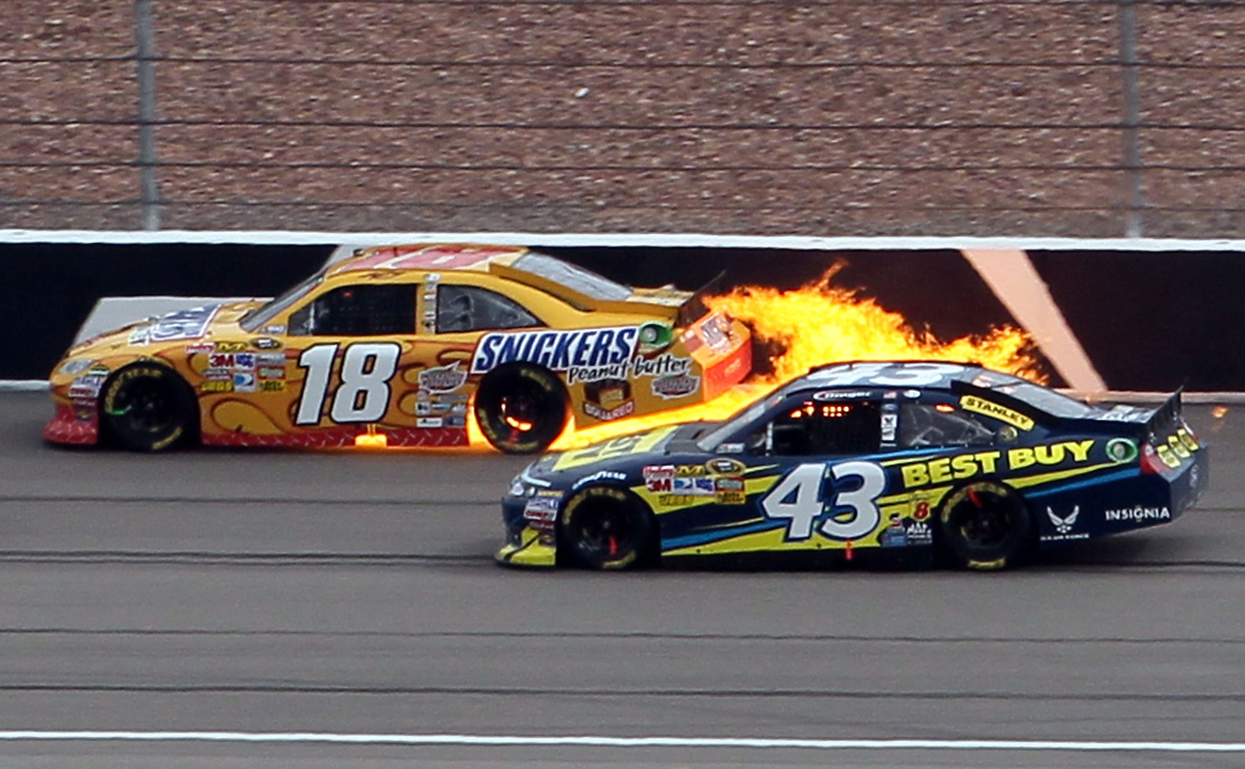 LAS VEGAS, NV - MARCH 06:  Kyle Busch's #18 Snickers Toyota catches fire after his engine blew up during the NASCAR Sprint Cup Series Kobalt Tools 400 at Las Vegas Motor Speedway on March 6, 2011 in Las Vegas, Nevada.  (Photo by Jeff Gross/Getty Images)