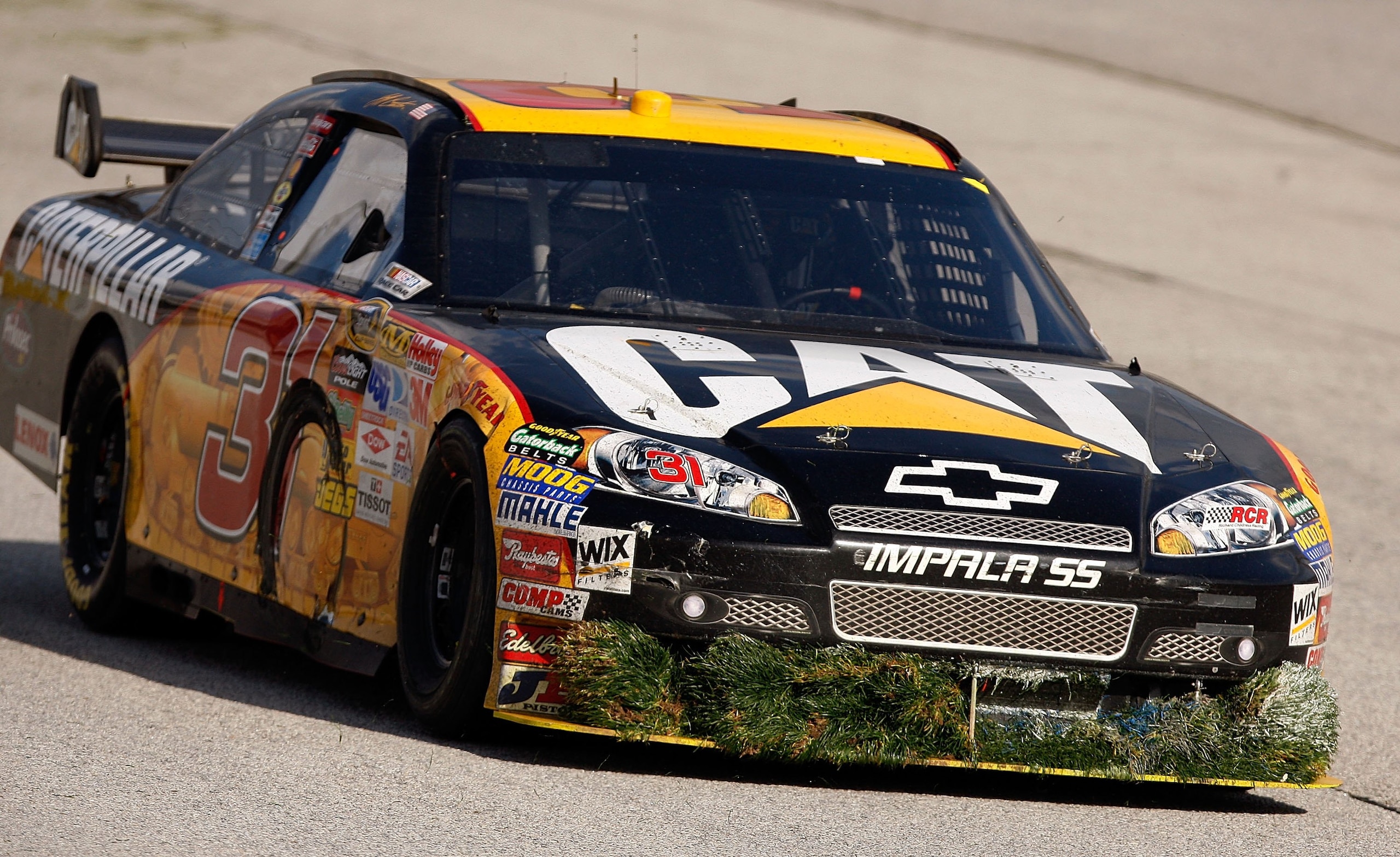 ATLANTA - MARCH 08:  Jeff Burton, driver of the #31 Caterpillar Chevrolet has a large ammount of grass stuck to the front of his car after going through the ballfield to avoid a wreck during the NASCAR Sprint Cup Series Kobalt Tools 500 at the Atlanta Mot