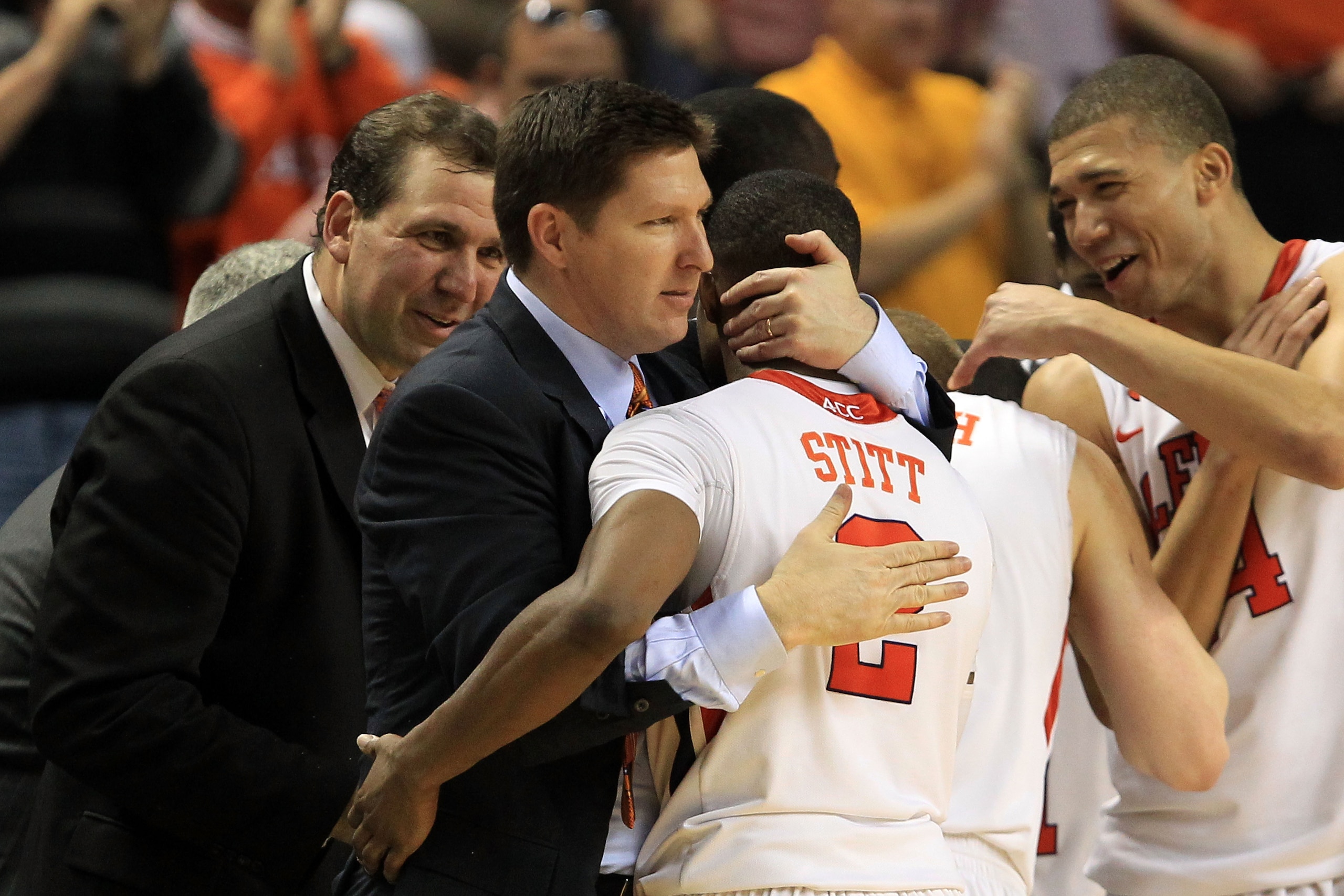 GREENSBORO, NC - MARCH 11:  Head coach Brad Brownell of the Clemson Tigers hugs player Demontez Stitt #2 after their 70-47 victory over the Boston College Eagles during the second half in the quarterfinals of the 2011 ACC men's basketball tournament at th