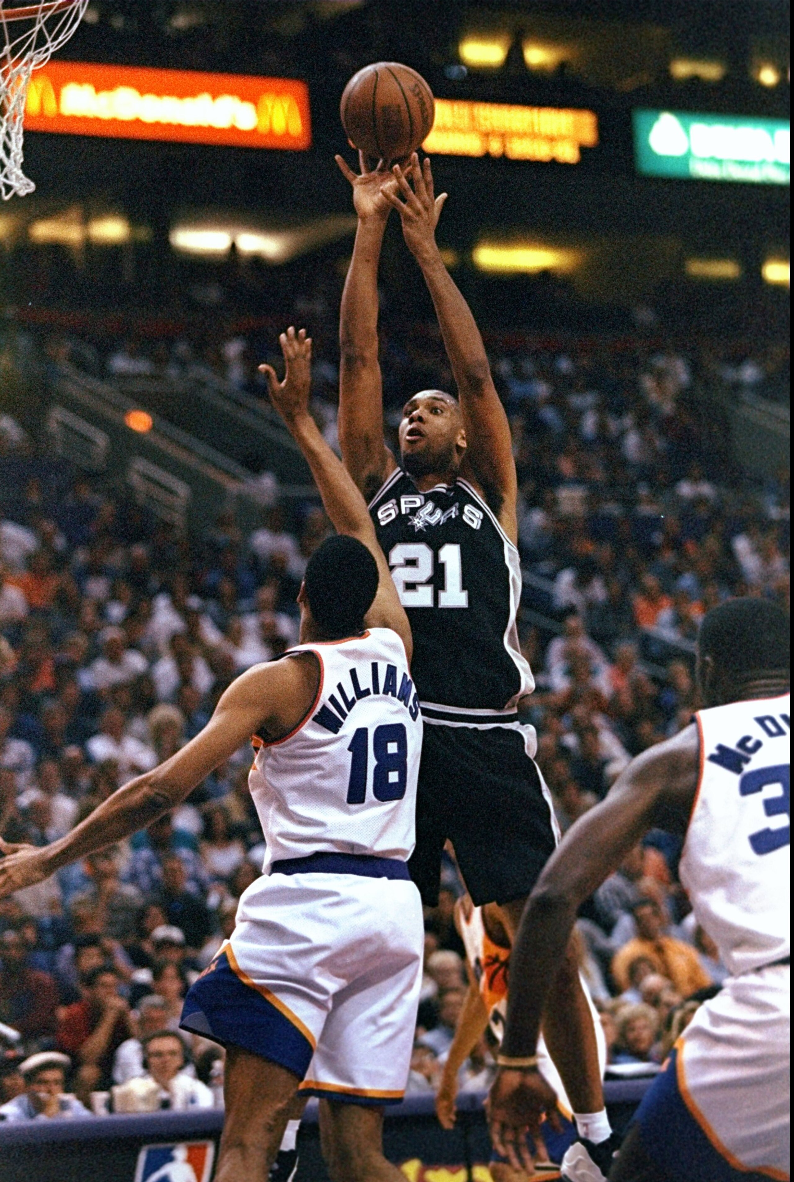 23 Apr 1998:  Tim Duncan #21 of the San Antonio Spurs shoots the ball over a player from the Phoenix Suns during a first round playoff game at the America West Arena in Phoenix, Arizona. The Spurs defeated the Suns 102-96. Mandatory Credit: Tom Hauck  /Al