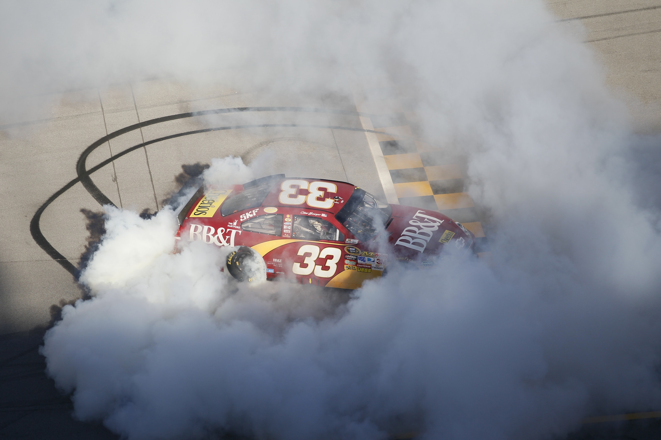 TALLADEGA, AL - OCTOBER 31:  Clint Bowyer, driver of the #33 BB&T Chevrolet, does a burnout after winning the NASCAR Sprint Cup Series AMP Energy Juice 500 at Talladega Superspeedway on October 31, 2010 in Talladega, Alabama.  (Photo by Kevin C. Cox/Getty