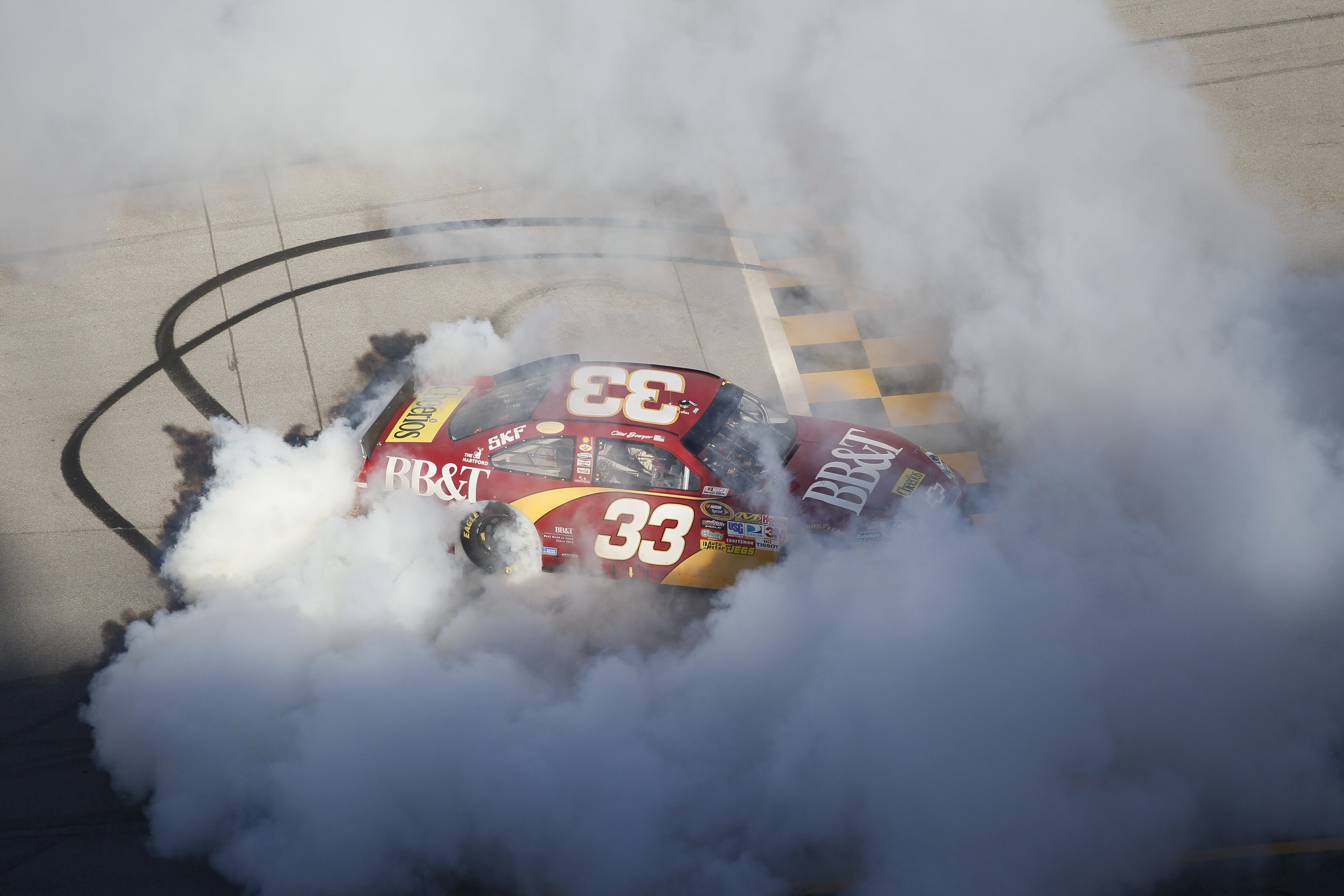 TALLADEGA, AL - OCTOBER 31:  Clint Bowyer, driver of the #33 BB&T Chevrolet, does a burnout after winning the NASCAR Sprint Cup Series AMP Energy Juice 500 at Talladega Superspeedway on October 31, 2010 in Talladega, Alabama.  (Photo by Kevin C. Cox/Getty