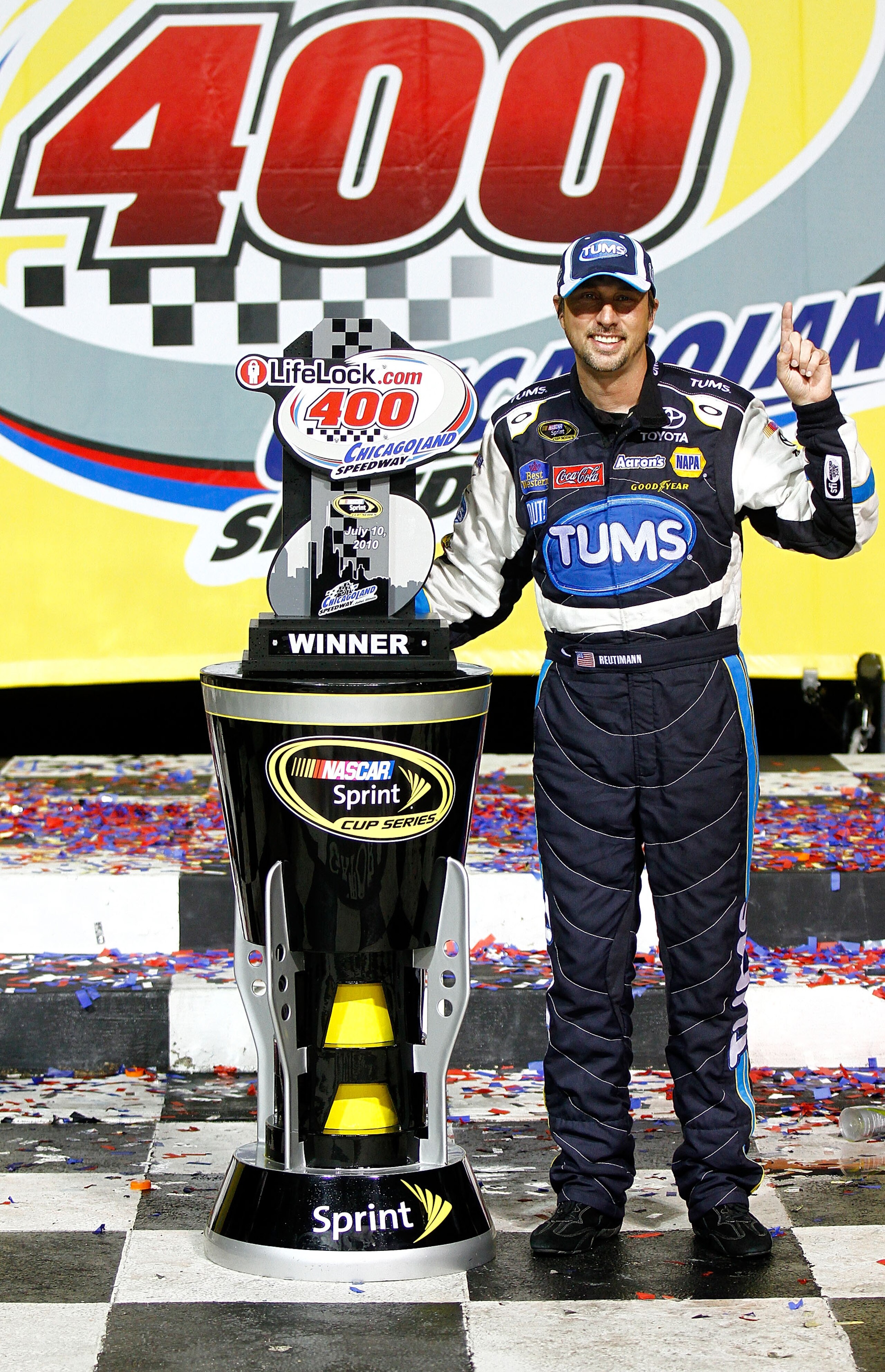 JOLIET, IL - JULY 10:  David Reutimann, driver of the #00 TUMS Toyota, celebrates with the trophy in victory lane after he won the NASCAR Sprint Cup Series LIFELOCK.COM 400 at the Chicagoland Speedway on July 10, 2010 in Joliet, Illinois.  (Photo by Jason