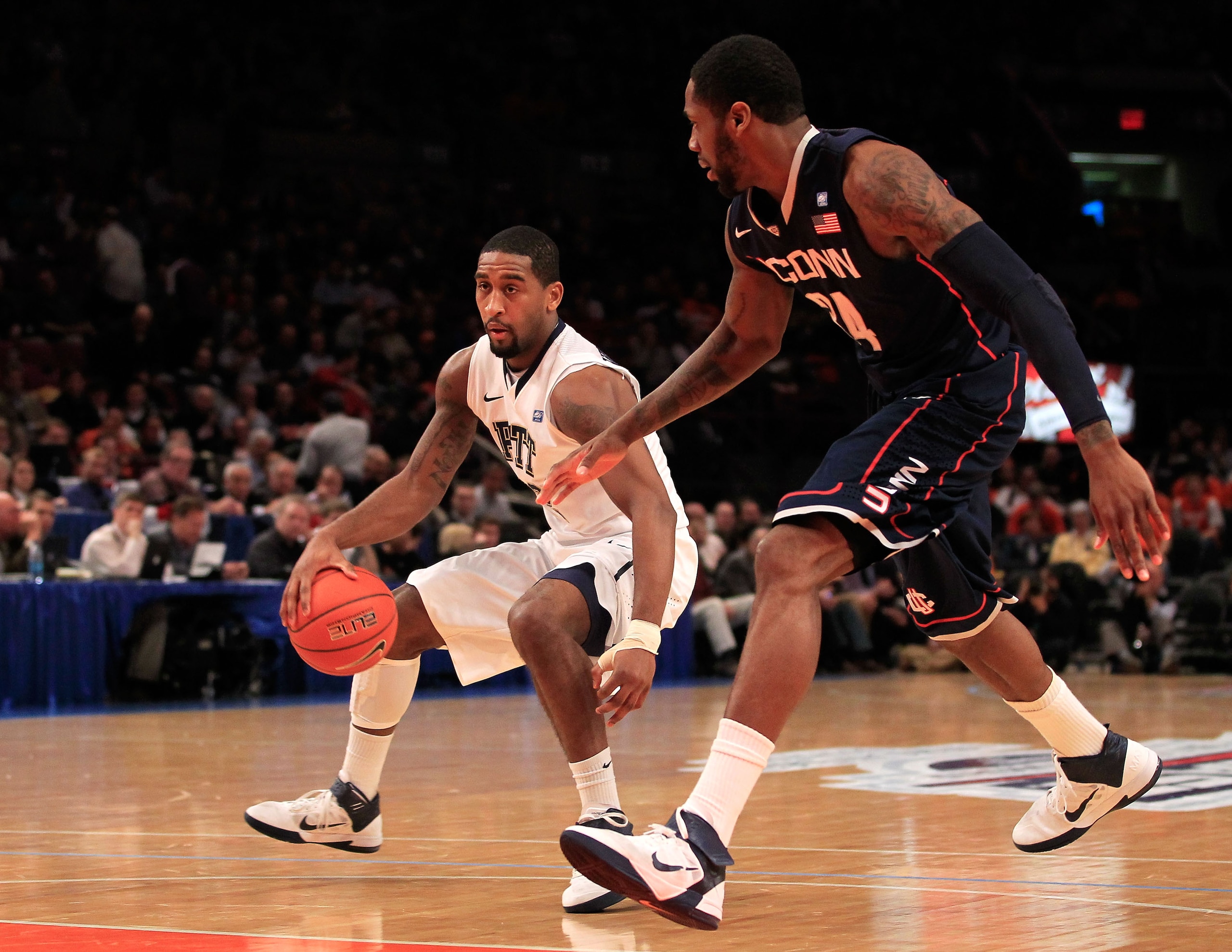 NEW YORK, NY - MARCH 10: Brad Wanamaker #22 of the Pittsburgh Panthers dribbles the ball against Alex Oriakhi #34 of the Connecticut Huskies during the quarterfinals of the 2011 Big East Men's Basketball Tournament presented by American Eagle Outfitters