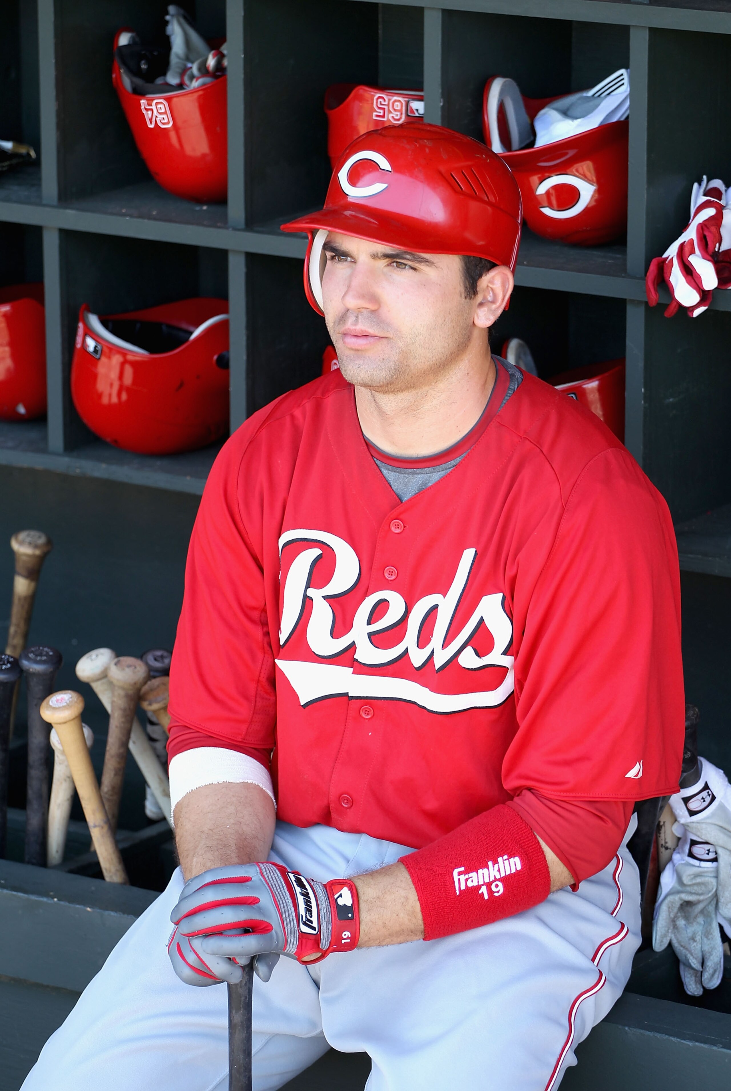 SURPRISE, AZ - MARCH 11:  Joey Votto #19 of the Cincinnati Reds sits in the dugout during the spring training game against the Texas Rangers at Surprise Stadium on March 11, 2011 in Surprise, Arizona.  (Photo by Christian Petersen/Getty Images)
