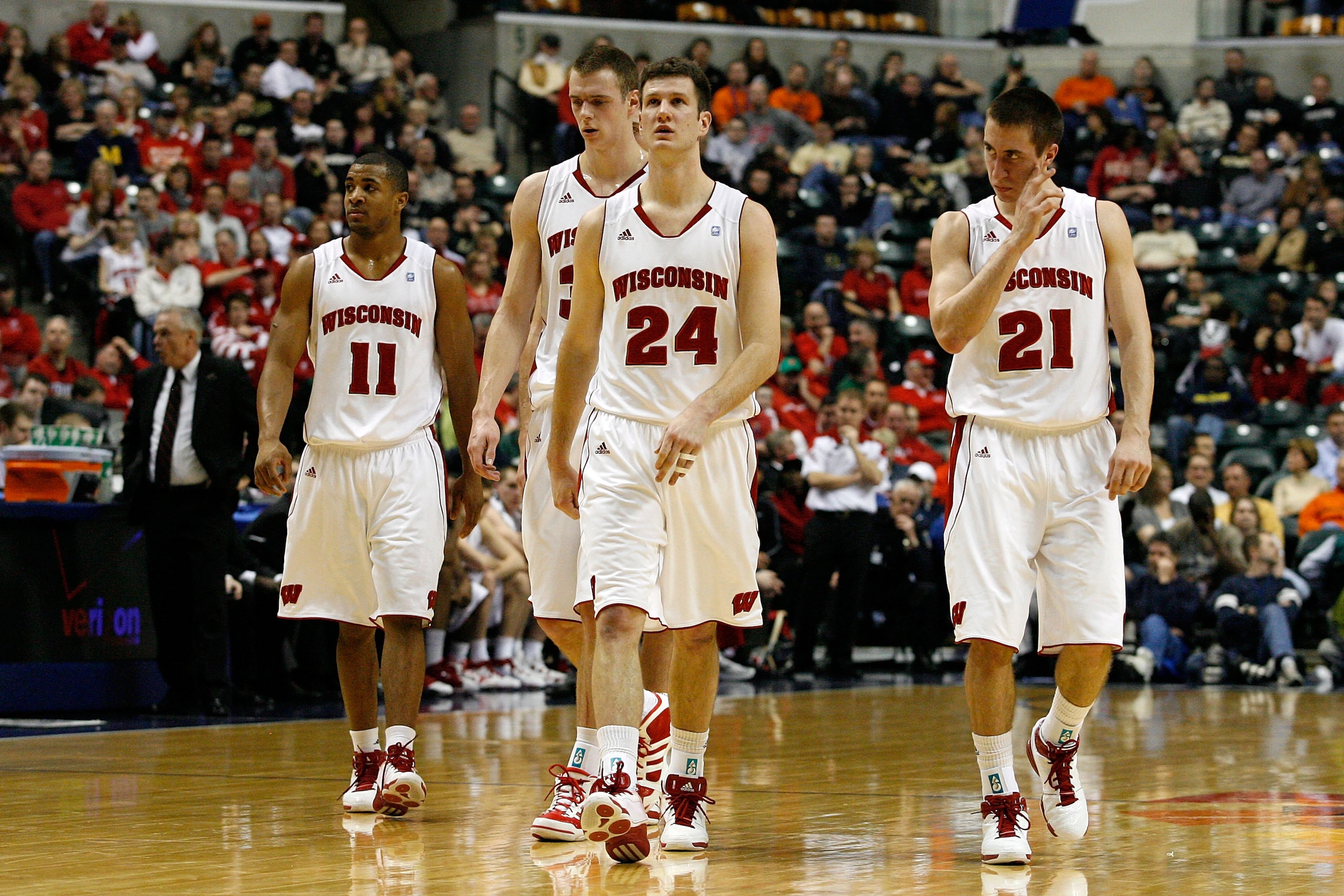 INDIANAPOLIS, IN - MARCH 11:  (L-R) Jordan Taylor #11, Jon Leuer #30, Tim Jarmusz #24 and Josh Gasser #21 of the Wisconsin Badgers walk up court against the Penn State Nittany Lions during the quarterfinals of the 2011 Big Ten Men's Basketball Tournament