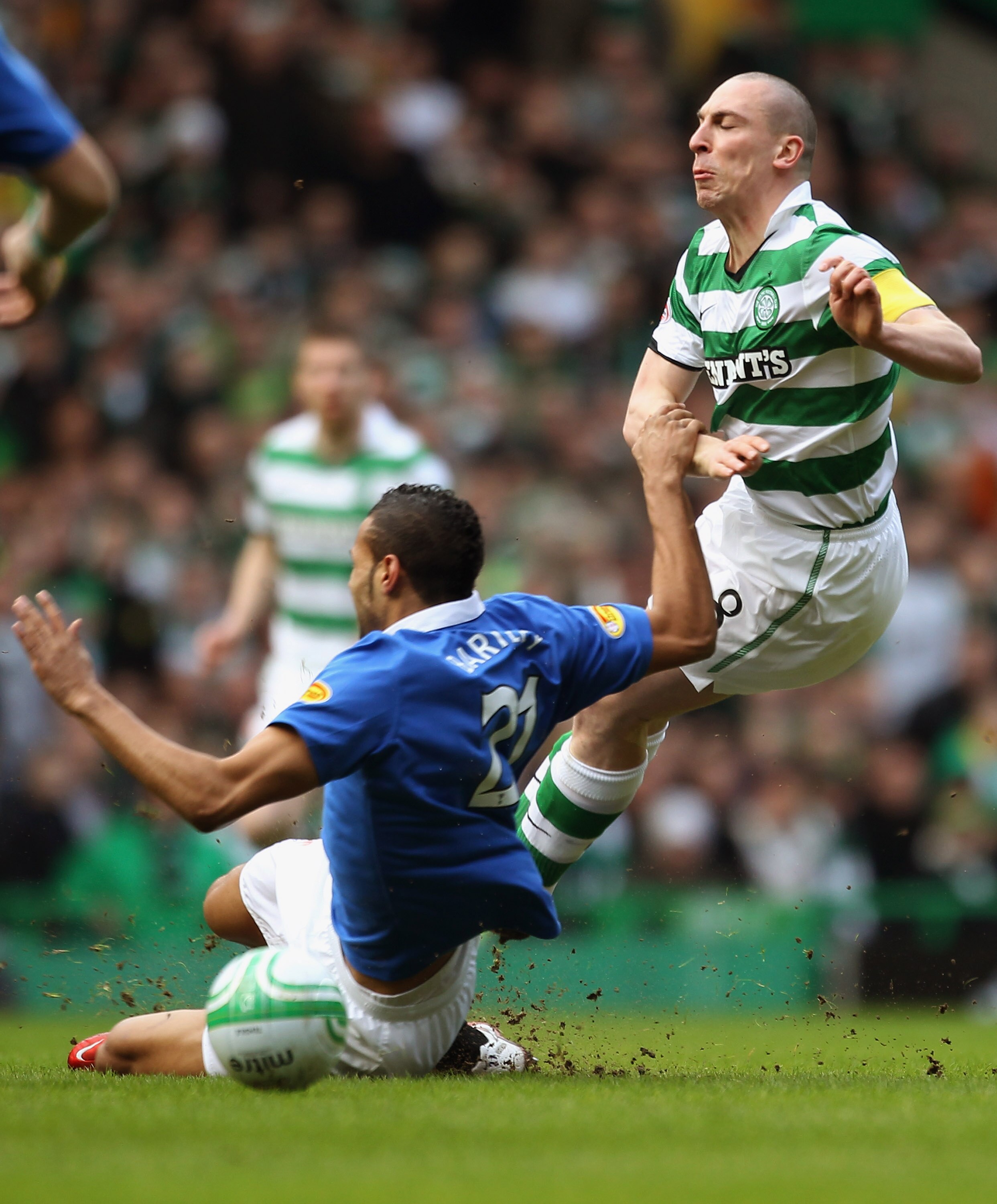 GLASGOW, SCOTLAND - FEBRUARY 20:  Scott Brown of Celtic is tackled by Kyle Bartley of Rangers during the Clydesdale Bank Premier League match between Celtic and Rangers at Celtic Park on February 20, 2011 in Glasgow, Scotland..  (Photo by Jeff J Mitchell/