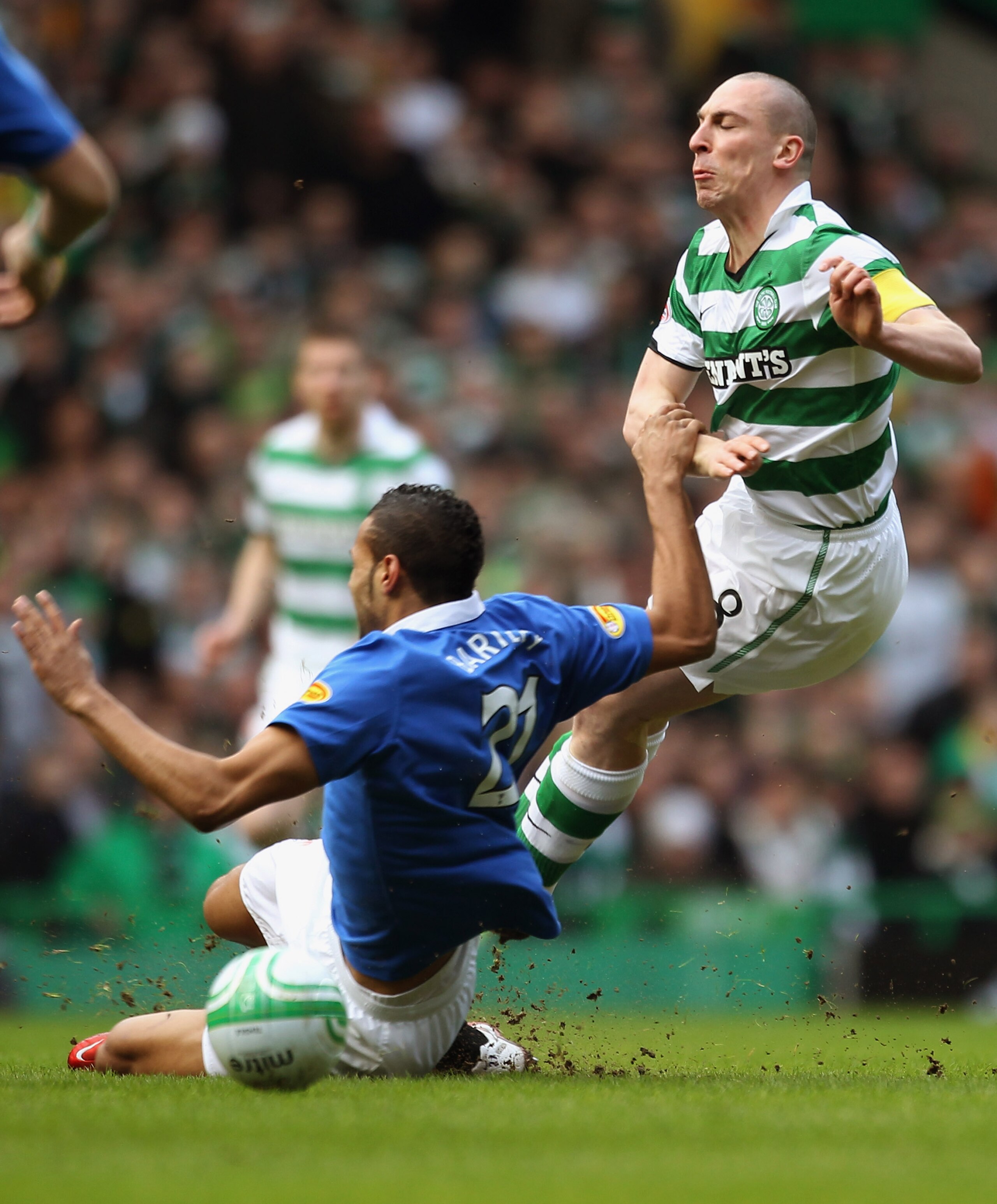 GLASGOW, SCOTLAND - FEBRUARY 20:  Scott Brown of Celtic is tackled by Kyle Bartley of Rangers during the Clydesdale Bank Premier League match between Celtic and Rangers at Celtic Park on February 20, 2011 in Glasgow, Scotland..  (Photo by Jeff J Mitchell/