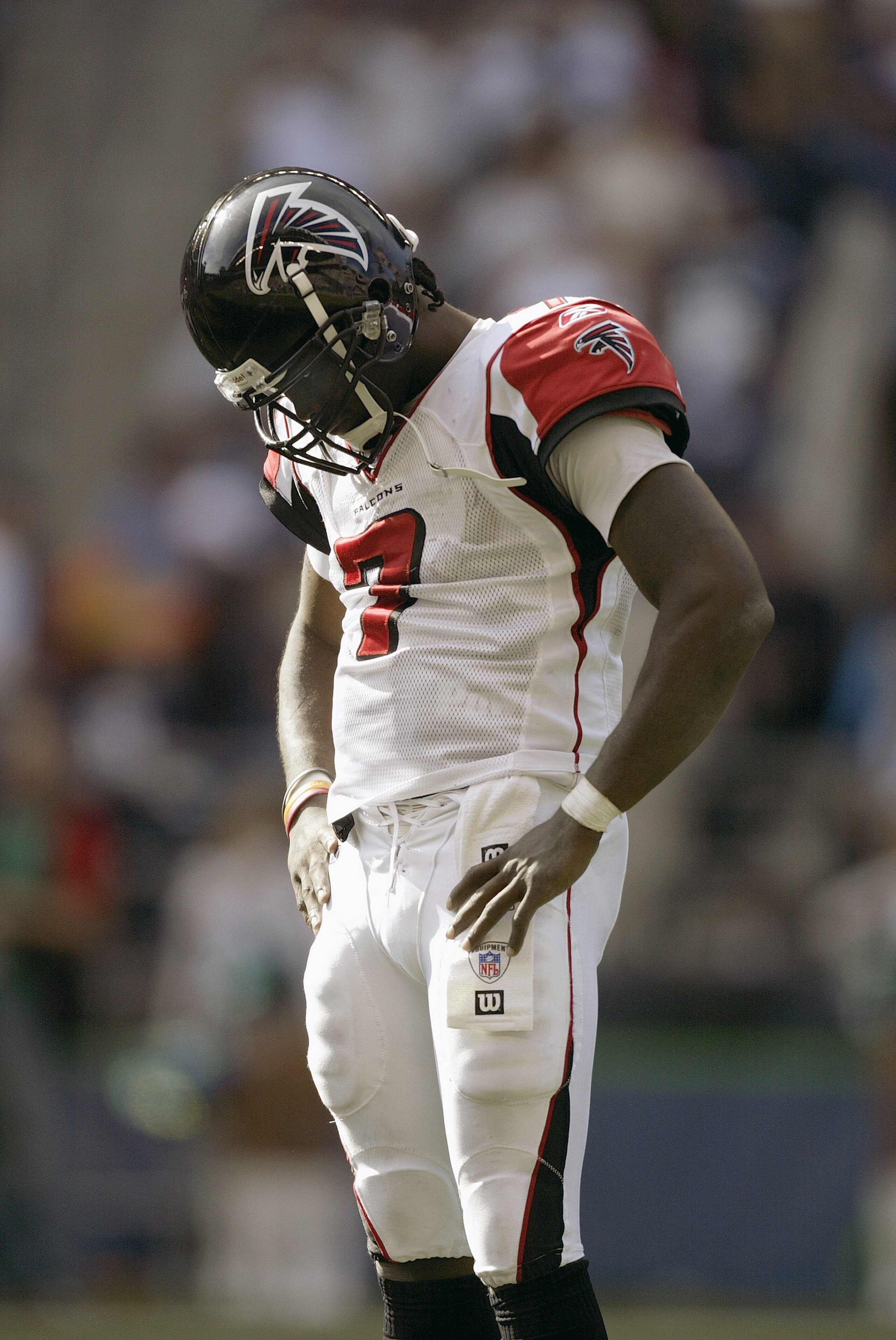 SEATTLE - SEPTEMBER 18: Michael Vick #7 of the Atlanta Falcons stands with his head downcast on the field during a game against the Seattle Seahawks at Qwest Field on September 18, 2005 in Seattle, Washington. Seahawks won 21-18. (Photo by Otto Greule Jr/