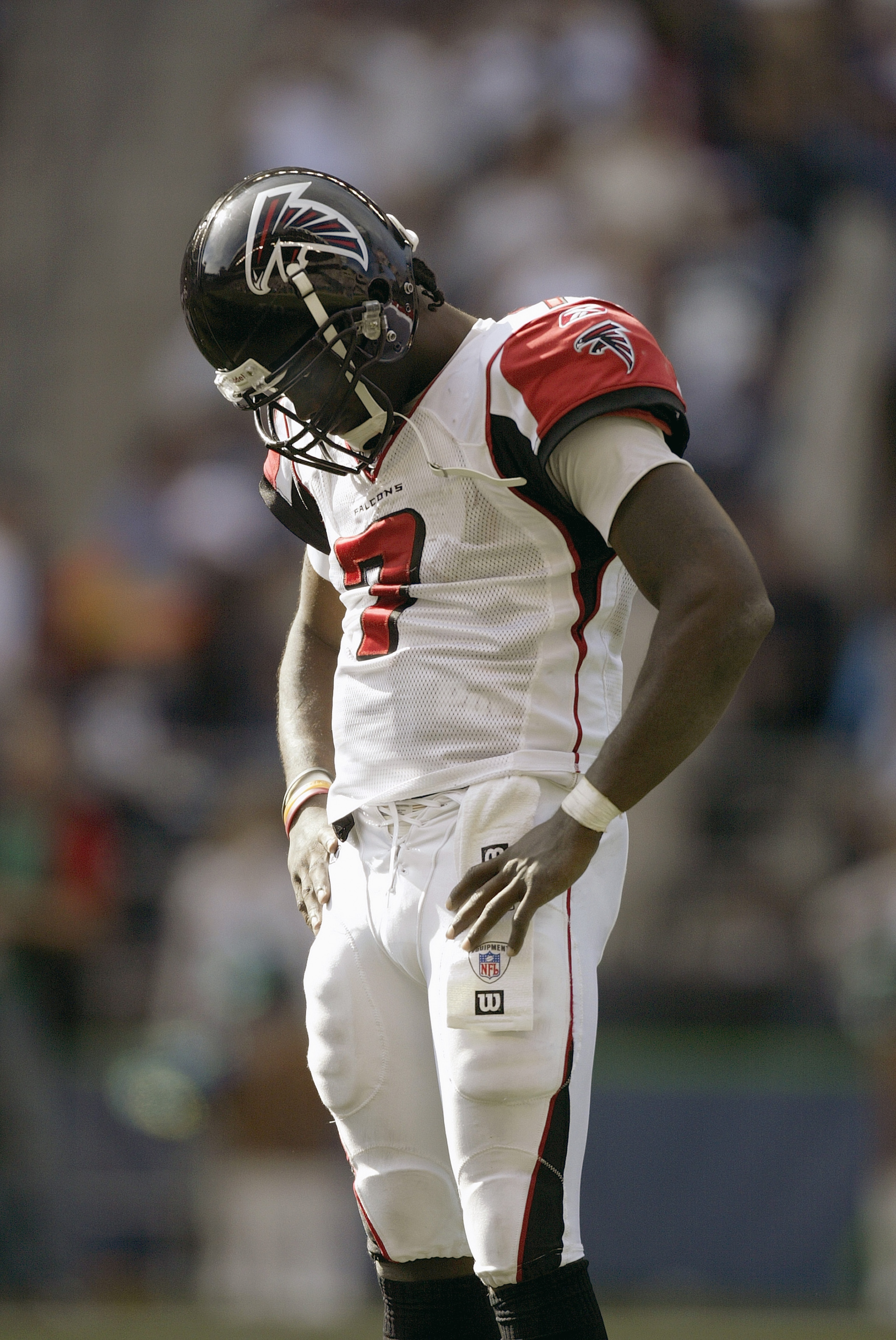SEATTLE - SEPTEMBER 18: Michael Vick #7 of the Atlanta Falcons stands with his head downcast on the field during a game against the Seattle Seahawks at Qwest Field on September 18, 2005 in Seattle, Washington. Seahawks won 21-18. (Photo by Otto Greule Jr/
