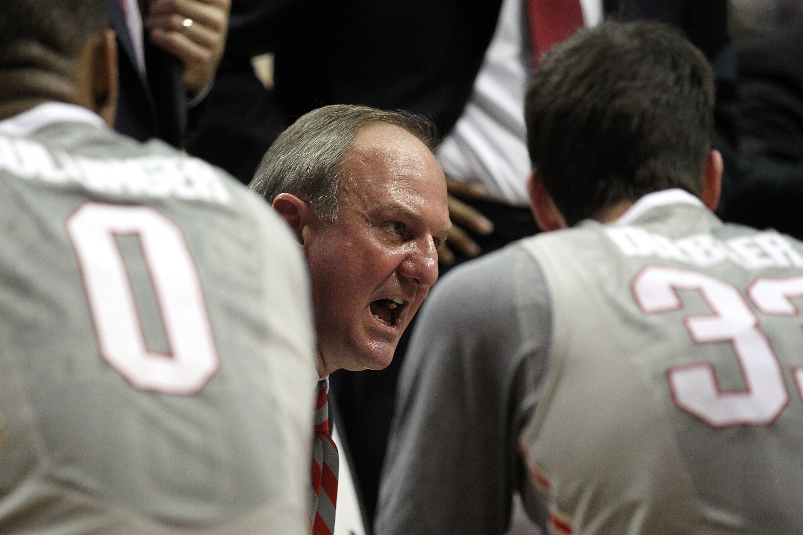 INDIANAPOLIS, IN - MARCH 13:  Head coach Thad Matta of the Ohio State Buckeyes talks with his players during a timeout including Jon Diebler #33 and Jared Sullinger #0 against the Penn State Nittany Lions during the championship game of the 2011 Big Ten M