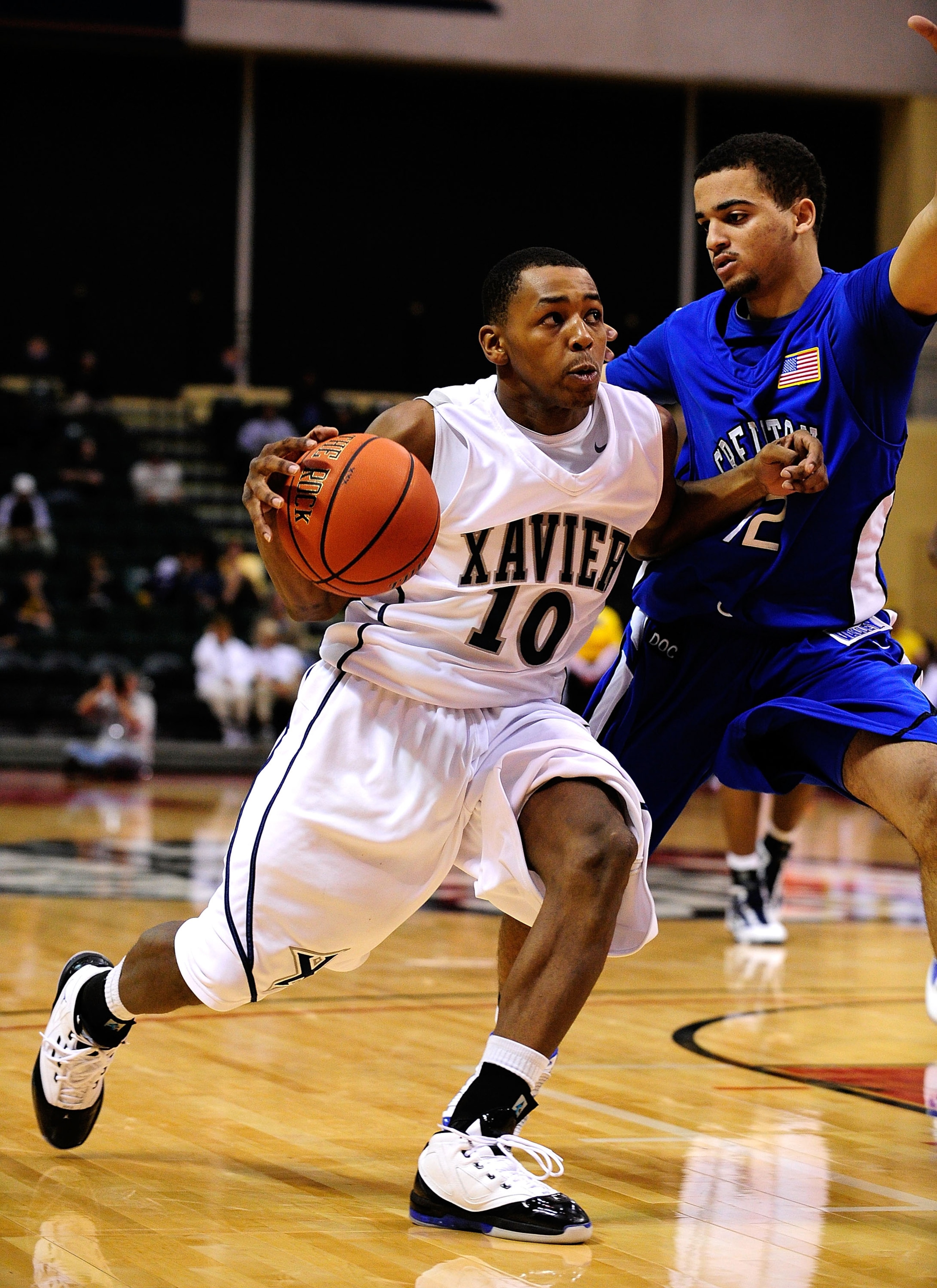 ORLANDO, FL - NOVEMBER 27:  Mark Lyons #10 of the Xavier Muskateers drives against Andrew Bock #12 of the Creighton Blue Jays during the Old Spice Classic at Disney's Milk House on November 27, 2009 in Orlando, Florida. Xavier defeated Creighton 80-67.  (