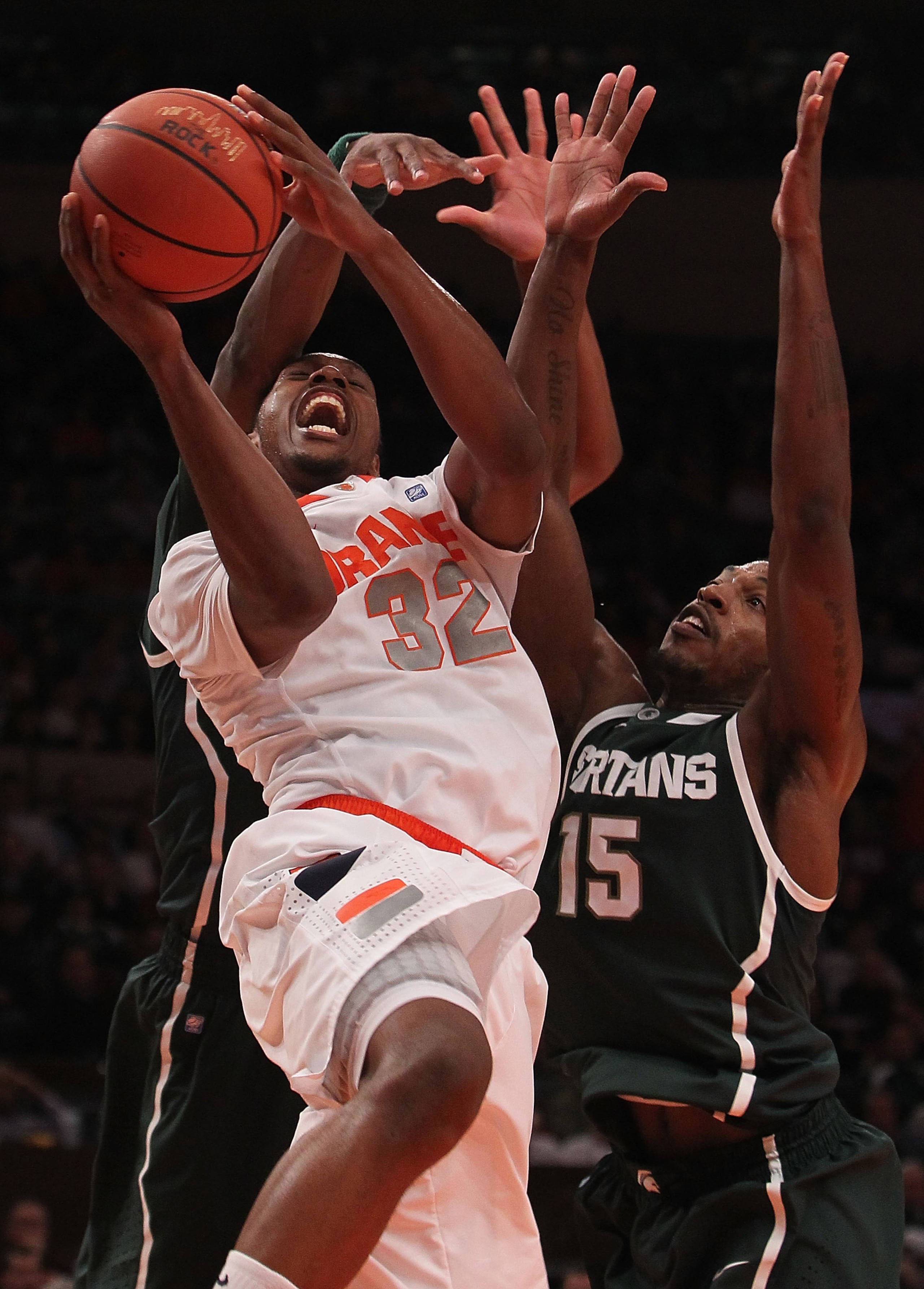 NEW YORK, NY - DECEMBER 07:  Kris Joseph #32 of Syracuse Orange is fouled against the Michigan State Spartans during their game at the Jimmy V Classic at Madison Square Garden on December 7, 2010 in New York City.  (Photo by Nick Laham/Getty Images)