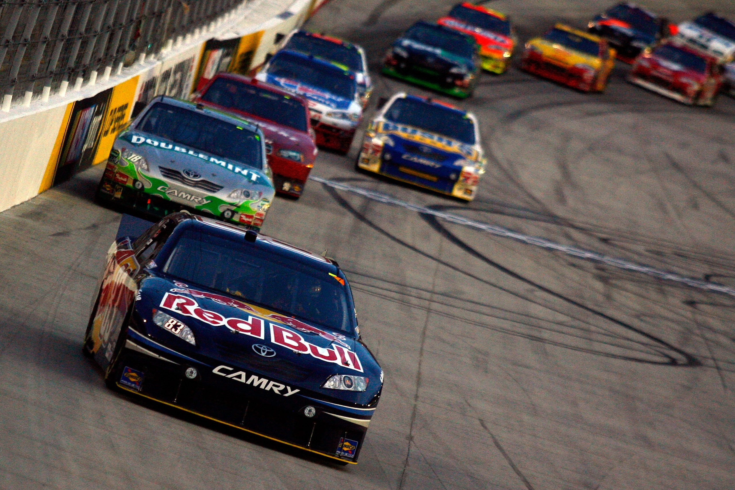 BRISTOL, TN - AUGUST 21:  Reen Sorenson, driver of the #83 Red Bull Toyota, leads a group of cars during the NASCAR Sprint Cup Series IRWIN Tools Night Race at Bristol Motor Speedway on August 21, 2010 in Bristol, Tennessee.  (Photo by Jason Smith/Getty I