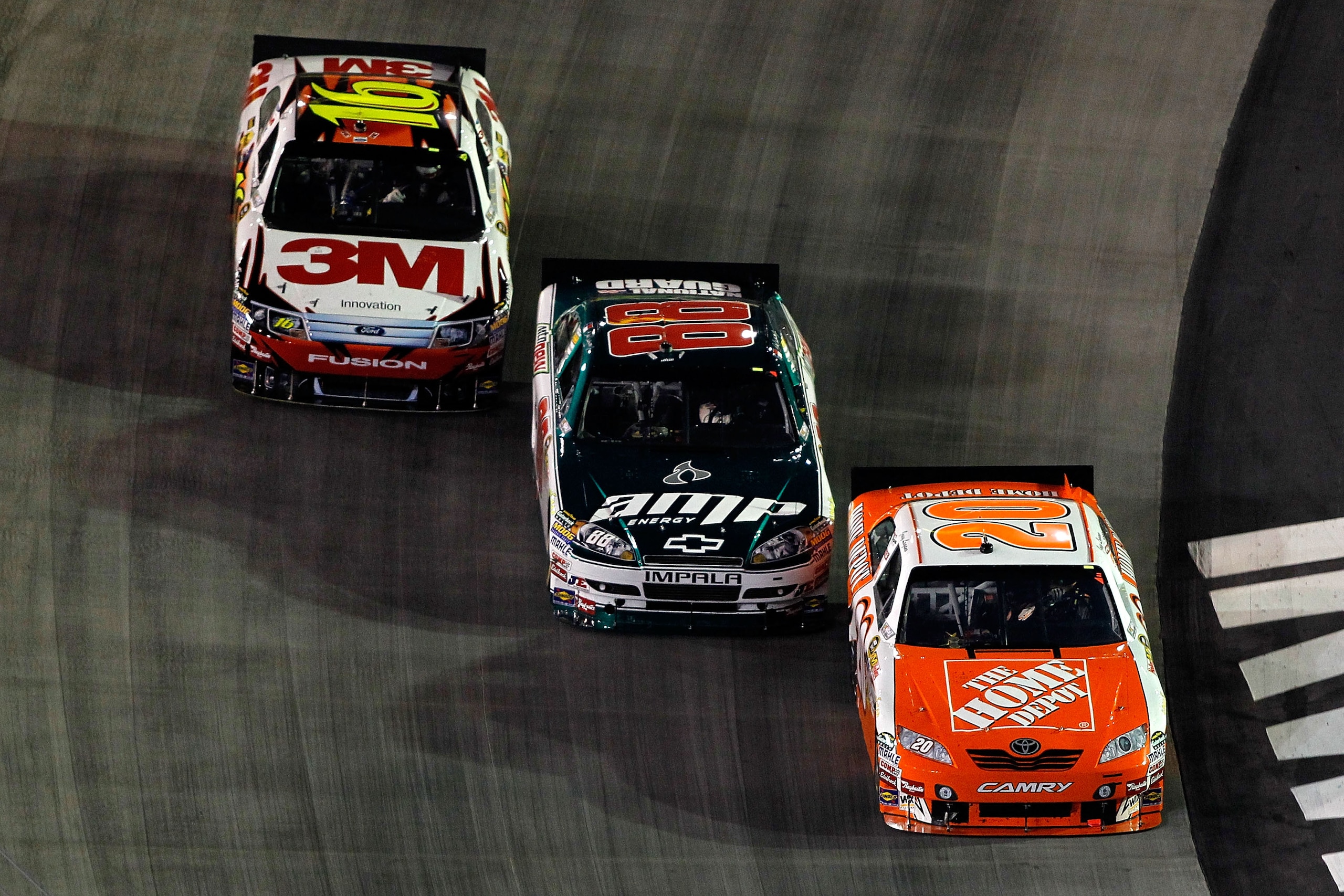 BRISTOL, TN - AUGUST 21:  Joey Logano, driver of the #20 Home Depot Toyota, Dale Earnhardt Jr., driver of the #88 AMP Energy/National Guard Chevrolet, and Greg Biffle, driver of the #16 3M Ford, drive during the NASCAR Sprint Cup Series IRWIN Tools Night