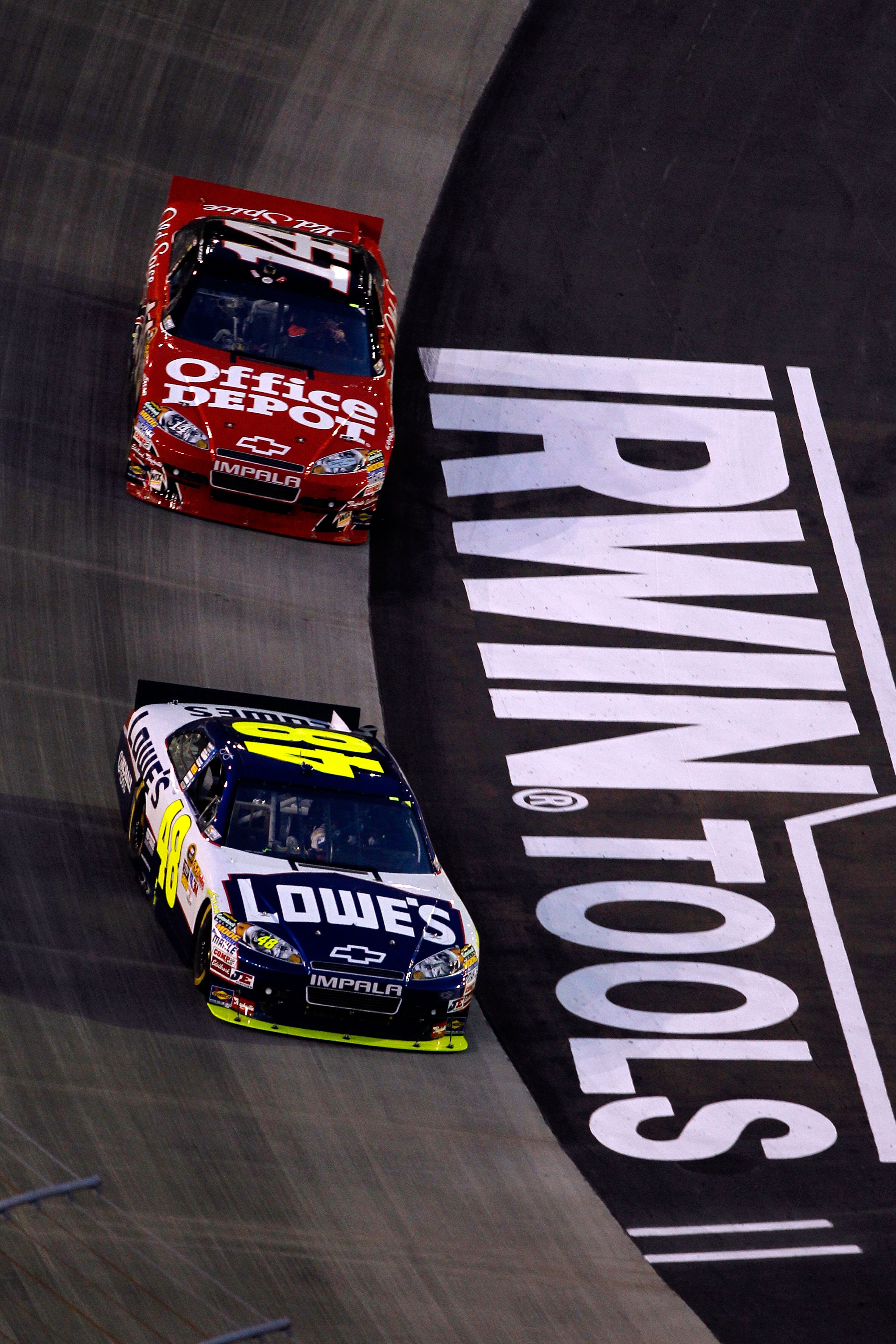 BRISTOL, TN - AUGUST 21:  Jimmie Johnson, driver of the #48 Lowe's Chevrolet, leads Tony Stewart, driver of the #14 Office Depot/Old Spice Chevrolet, during the NASCAR Sprint Cup Series IRWIN Tools Night Race at Bristol Motor Speedway on August 21, 2010 i