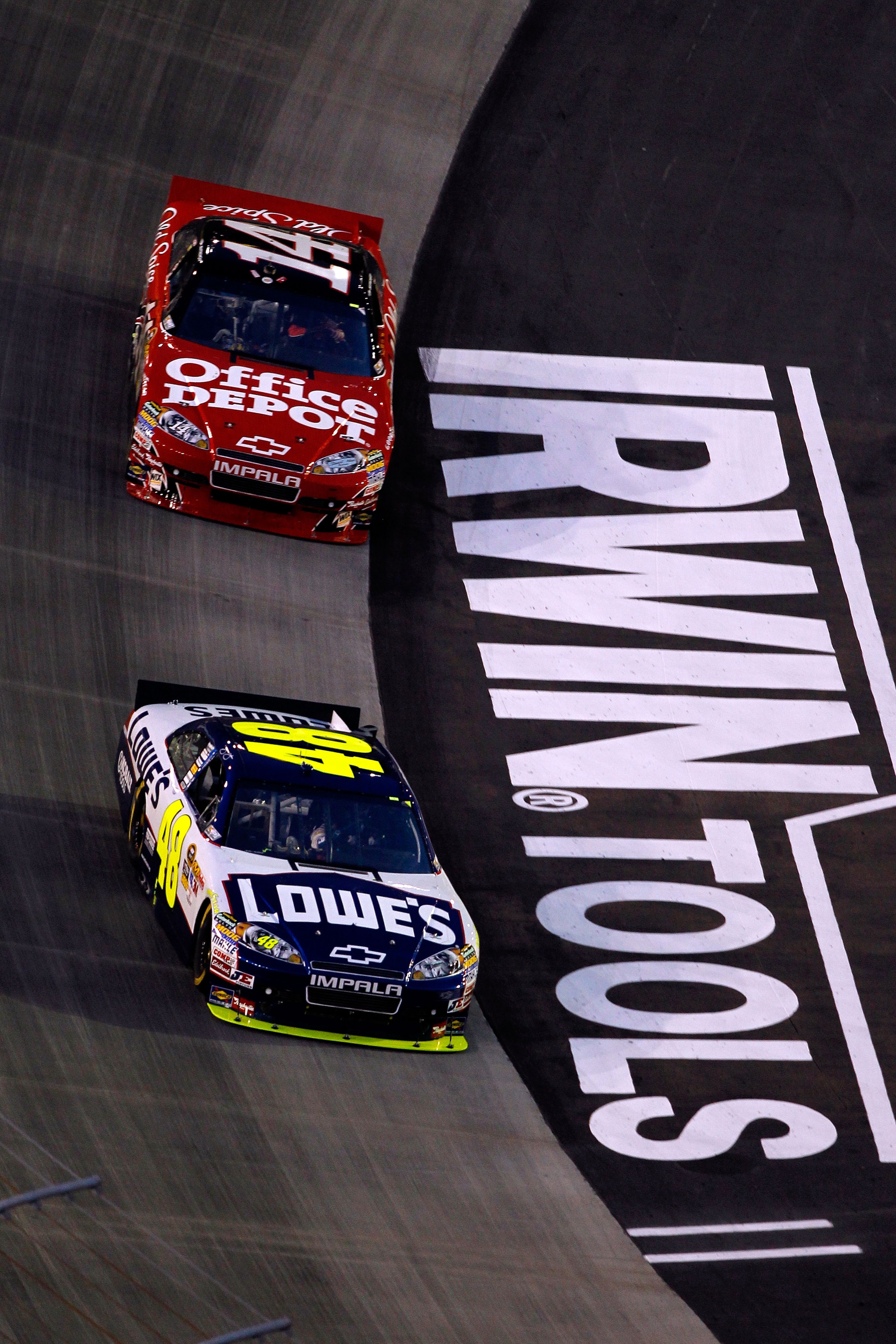 BRISTOL, TN - AUGUST 21:  Jimmie Johnson, driver of the #48 Lowe's Chevrolet, leads Tony Stewart, driver of the #14 Office Depot/Old Spice Chevrolet, during the NASCAR Sprint Cup Series IRWIN Tools Night Race at Bristol Motor Speedway on August 21, 2010 i