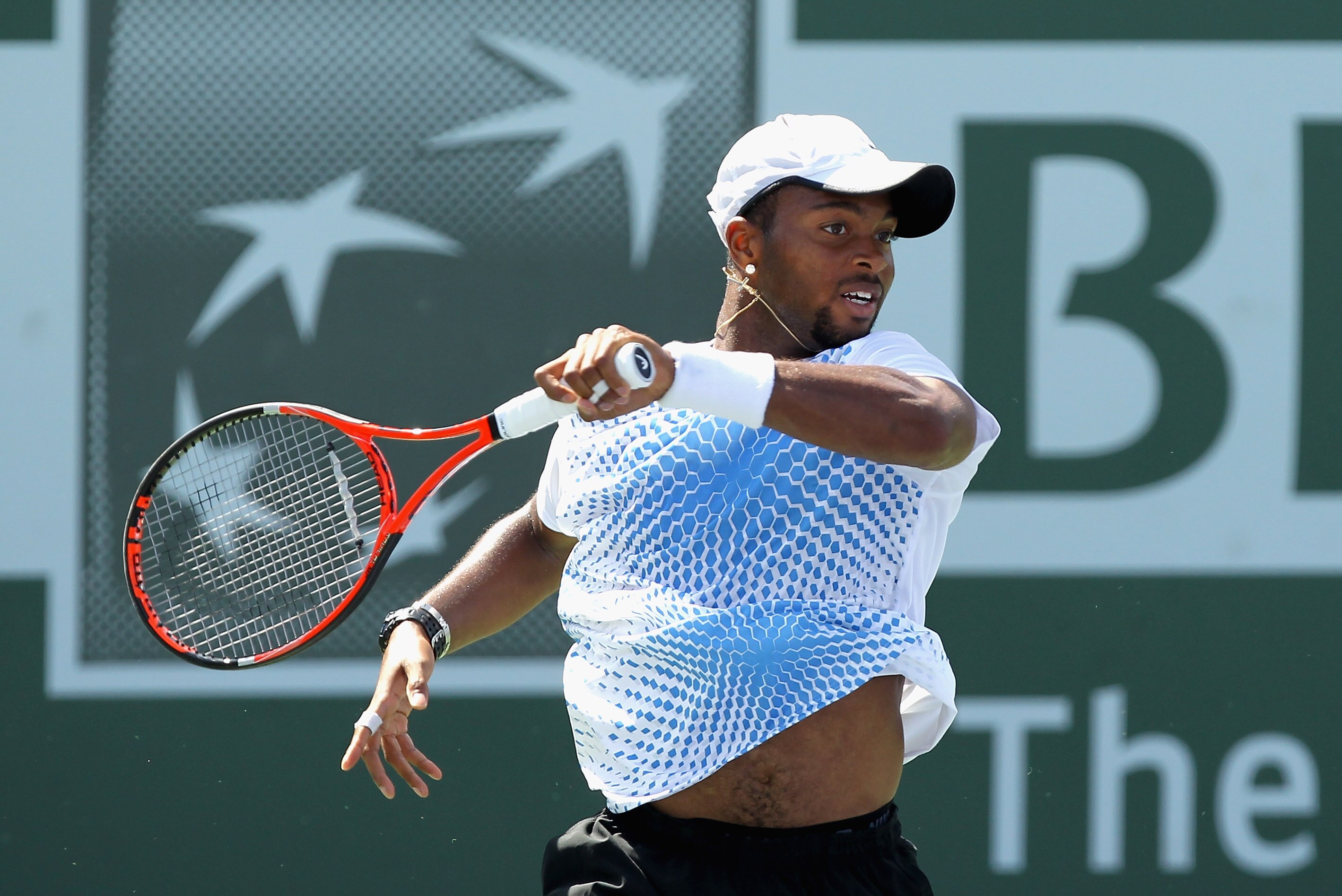 INDIAN WELLS, CA - MARCH 14:  Donald Young of the USA returns a shot to Tommy Robredo of Spain during the BNP Paribas Open at the Indian Wells Tennis Garden on March 14, 2011 in Indian Wells, California.  (Photo by Ezra Shaw/Getty Images)