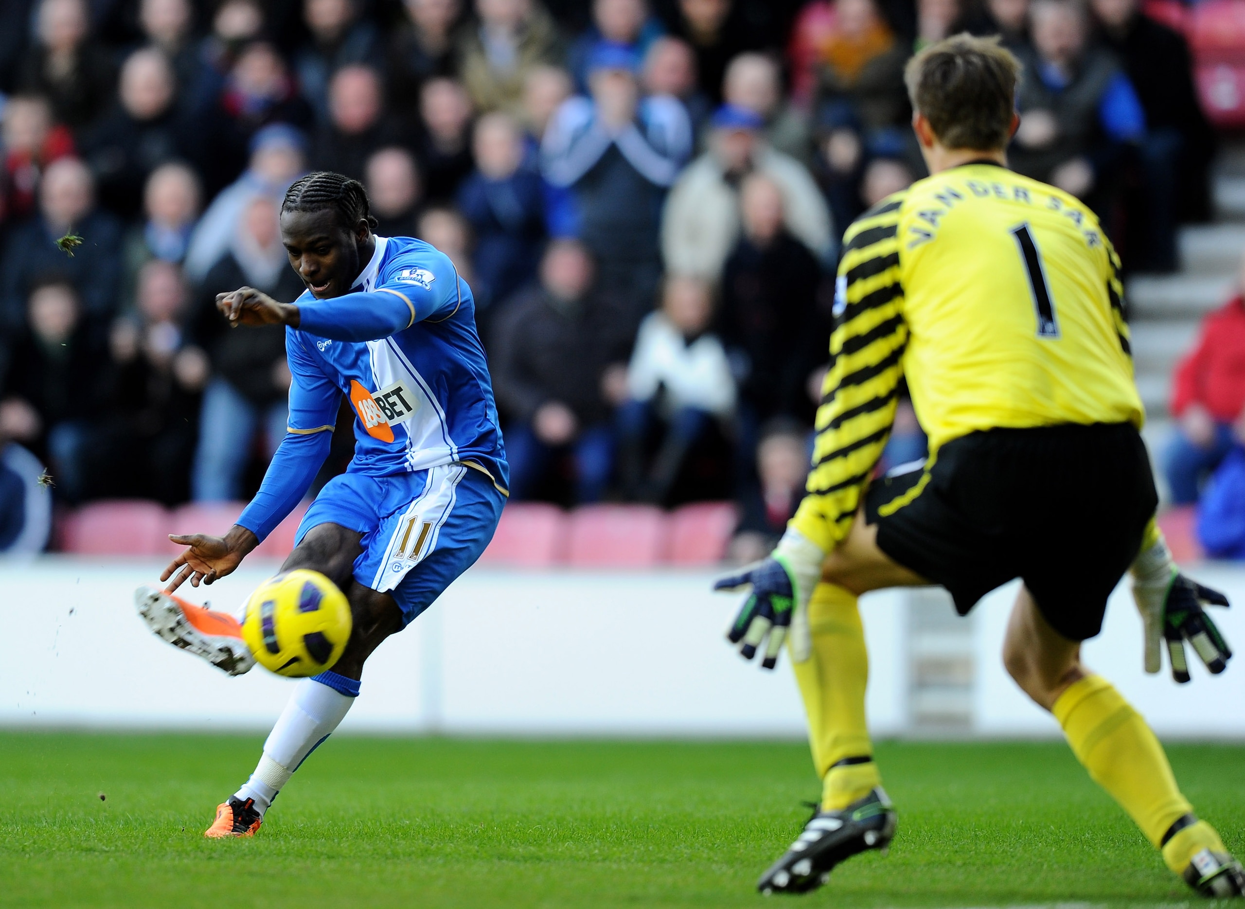 WIGAN, ENGLAND - FEBRUARY 26: Victor Moses of Wigan Athletic attempts a shot past Edwin van der Sar of Manchester United during the Barclays Premier League match between Wigan Athletic and Manchester United at the DW Stadium on February 26, 2011 in Wiga WIGAN, ENGLAND - FEBRUARY 26: Victor Moses of Wigan Athletic attempts a shot past Edwin van der Sar of Manchester United during the Barclays Premier League match between Wigan Athletic and Manchester United at the DW Stadium on February 26, 2011 in Wiga