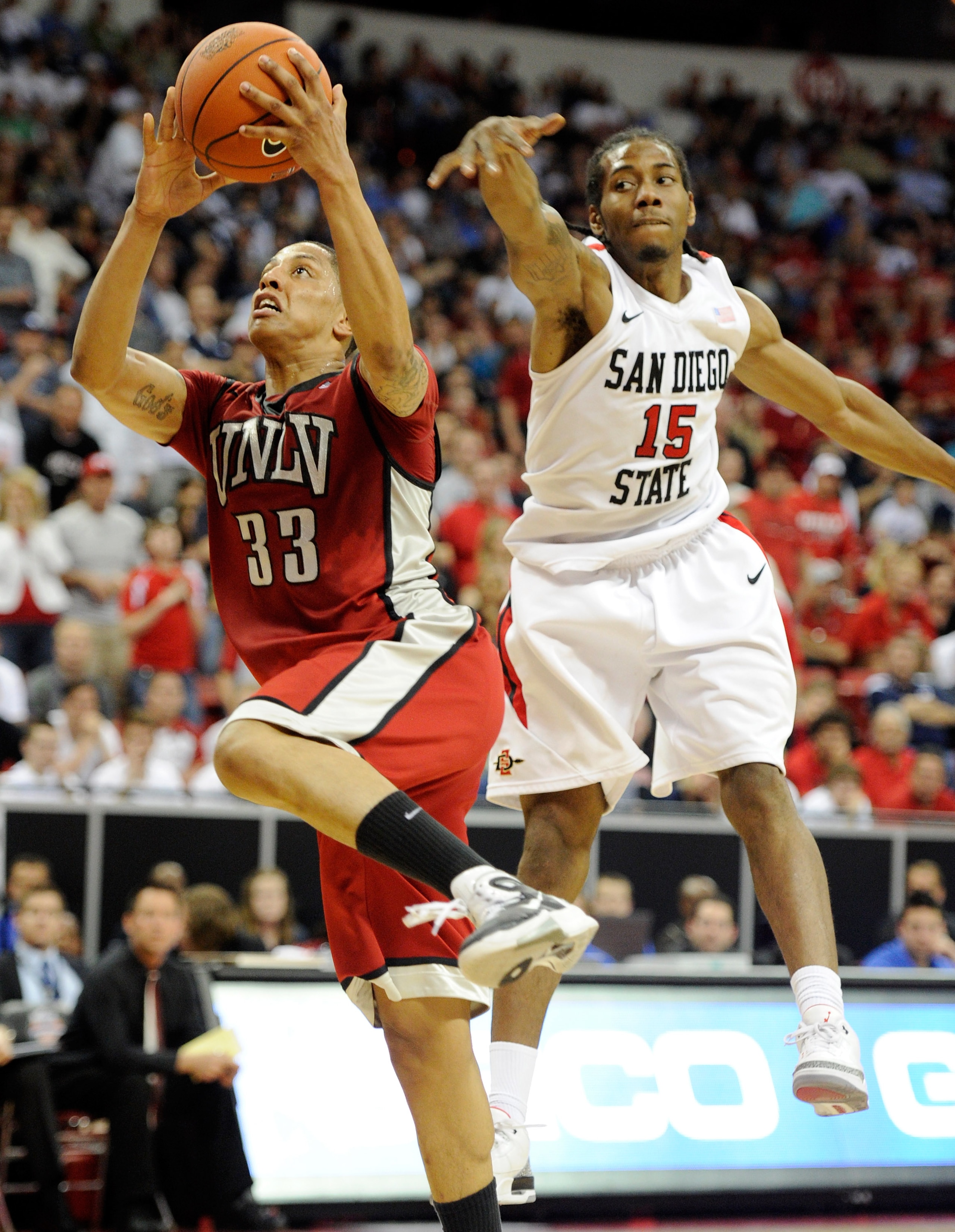 LAS VEGAS, NV - MARCH 11: Tre'Von Willis #33 of the UNLV Rebels drives to the basket in front of Kawhi Leonard #15 of the San Diego State Aztecs during a semifinal game of the Conoco Mountain West Conference Basketball tournament at the Thomas & Mack Cen LAS VEGAS, NV - MARCH 11: Tre'Von Willis #33 of the UNLV Rebels drives to the basket in front of Kawhi Leonard #15 of the San Diego State Aztecs during a semifinal game of the Conoco Mountain West Conference Basketball tournament at the Thomas & Mack Cen