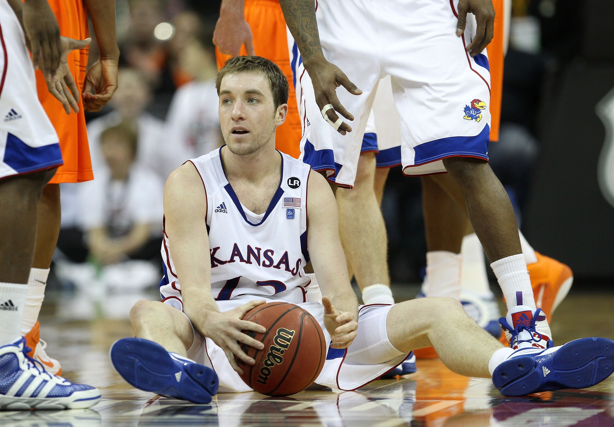 KANSAS CITY, MO - MARCH 10:  Brady Morningstar #12 of the Kansas Jayhawks sits on the court after being called for a foul on the Oklahoma State Cowboys during their quarterfinal game in the 2011 Phillips 66 Big 12 Men's Basketball Tournament at Sprint Cen