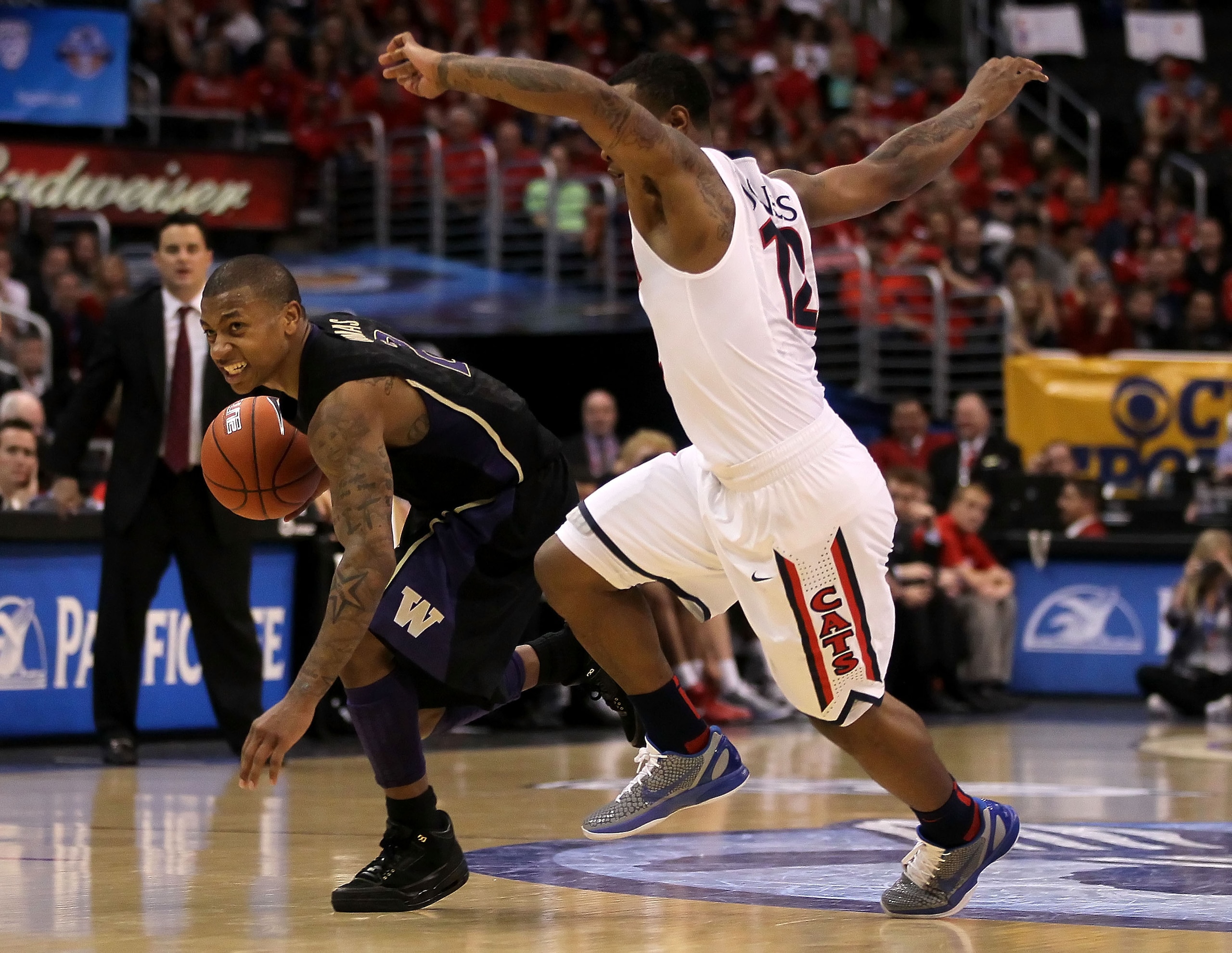 LOS ANGELES, CA - MARCH 12:  Isaiah Thomas #2 of the Washington Huskies drives on Lamont Jones #12 of the Arizona Wildcats in the championship game of the 2011 Pacific Life Pac-10 Men's Basketball Tournament at Staples Center on March 12, 2011 in Los Ange