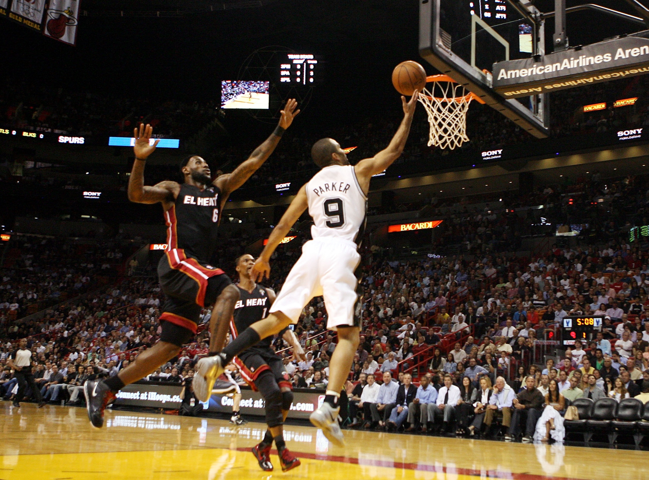 MIAMI - MARCH 14:  Guard Tony Parker #9 of the San Antonio Spurs drives on LeBron James #6 of the Miami Heat at American Airlines Arena on March 14, 2011 in Miami, Florida. NOTE TO USER: User expressly acknowledges and agrees that, by downloading and/or u