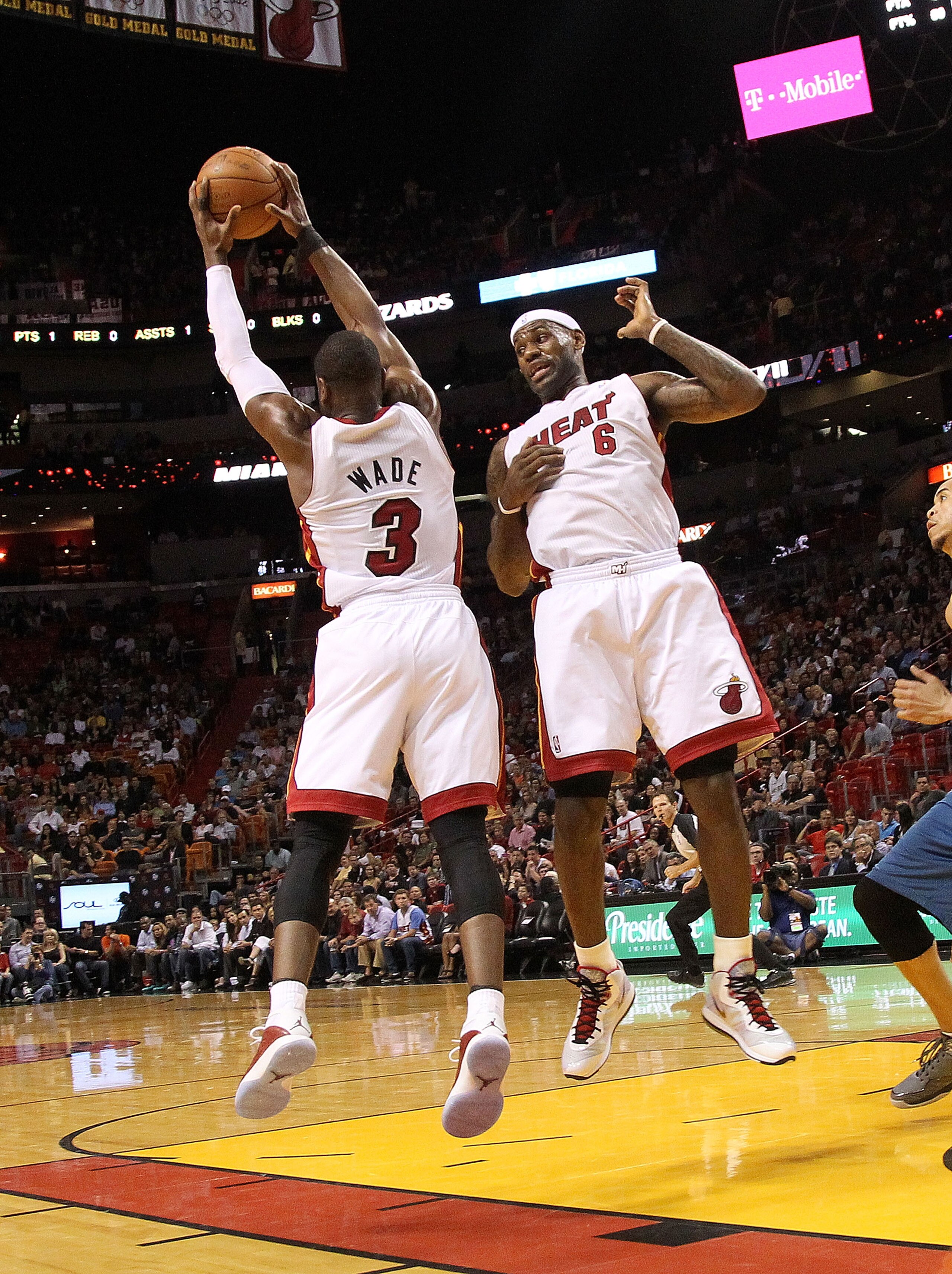 MIAMI, FL - FEBRUARY 25:  LeBron James #6 and Dwyane Wade #3 of the Miami Heat fight for a rebound during a game against the Washington Wizards at American Airlines Arena on February 25, 2011 in Miami, Florida. NOTE TO USER: User expressly acknowledges an