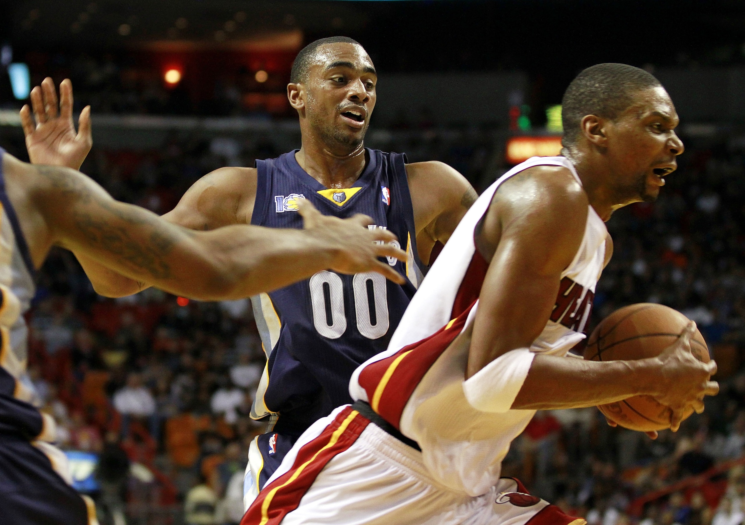 MIAMI - MARCH 12:  Forward Chris Bosh #1 of the Miami Heat drives against Forward Darrell Arthur #00 of the Memphis Grizzlies at American Airlines Arena on March 12, 2011 in Miami, Florida. NOTE TO USER: User expressly acknowledges and agrees that, by dow