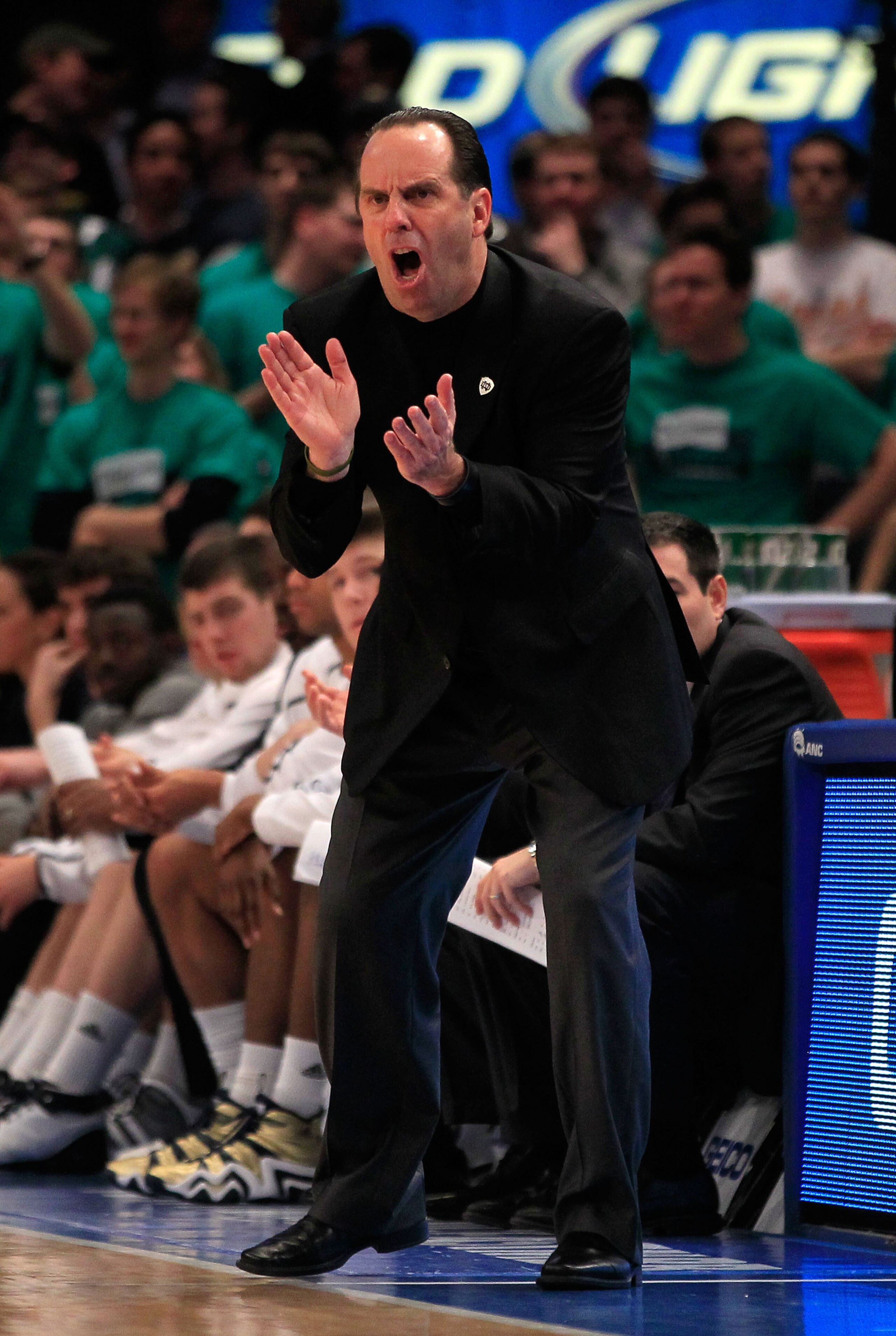 NEW YORK, NY - MARCH 10: Head coach Mike Brey of the Notre Dame Fighting Irish claps while looking on from the bench against the Cincinnati Bearcats during the quarterfinals of the 2011 Big East Men's Basketball Tournament presented by American Eagle Outf