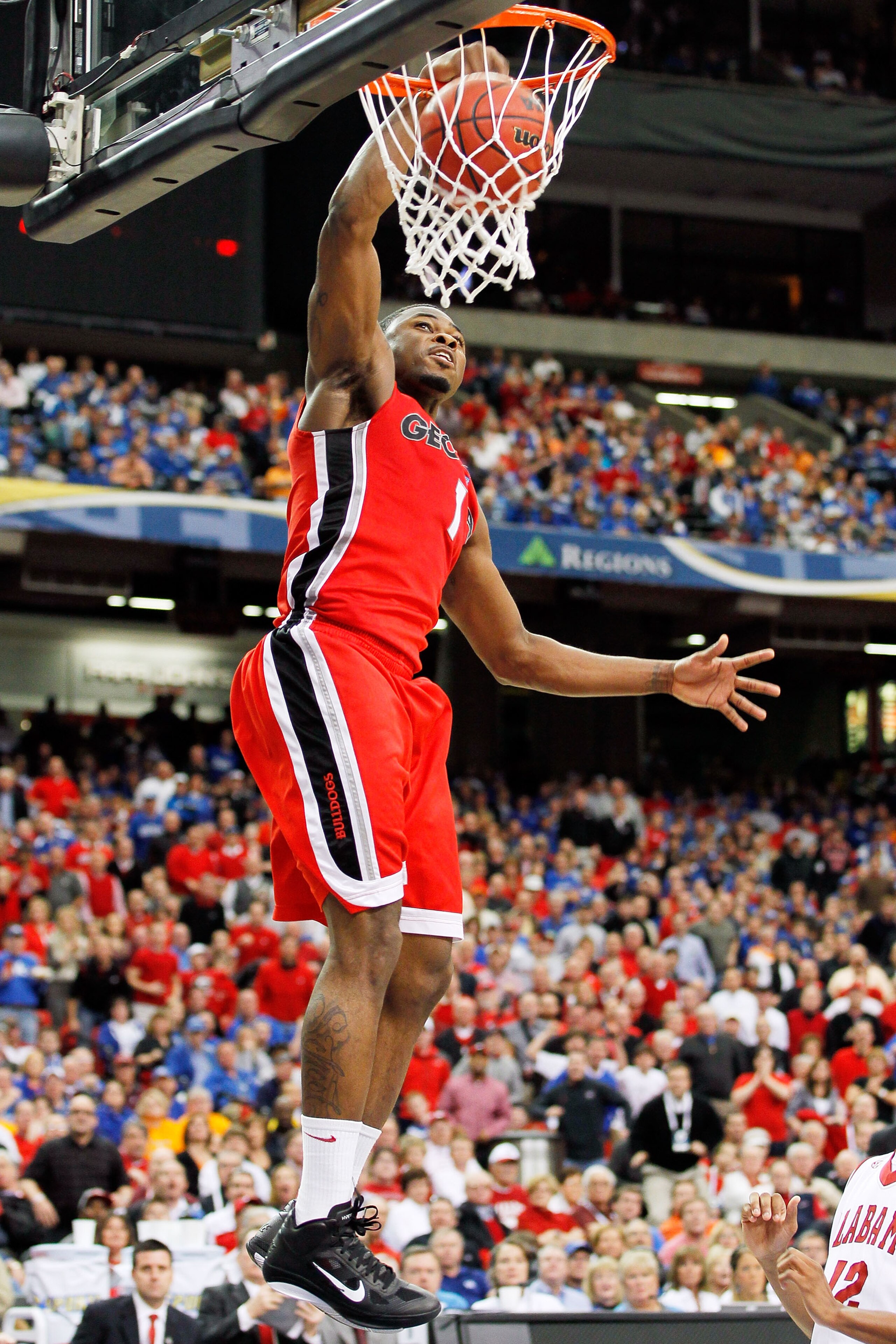 ATLANTA, GA - MARCH 11:  Travis Leslie #1 of the Georgia Bulldogs dunks on the Alabama Crimson Tide during the quarterfinals of the SEC Men's Basketball Tournament at Georgia Dome on March 11, 2011 in Atlanta, Georgia.  (Photo by Kevin C. Cox/Getty Images