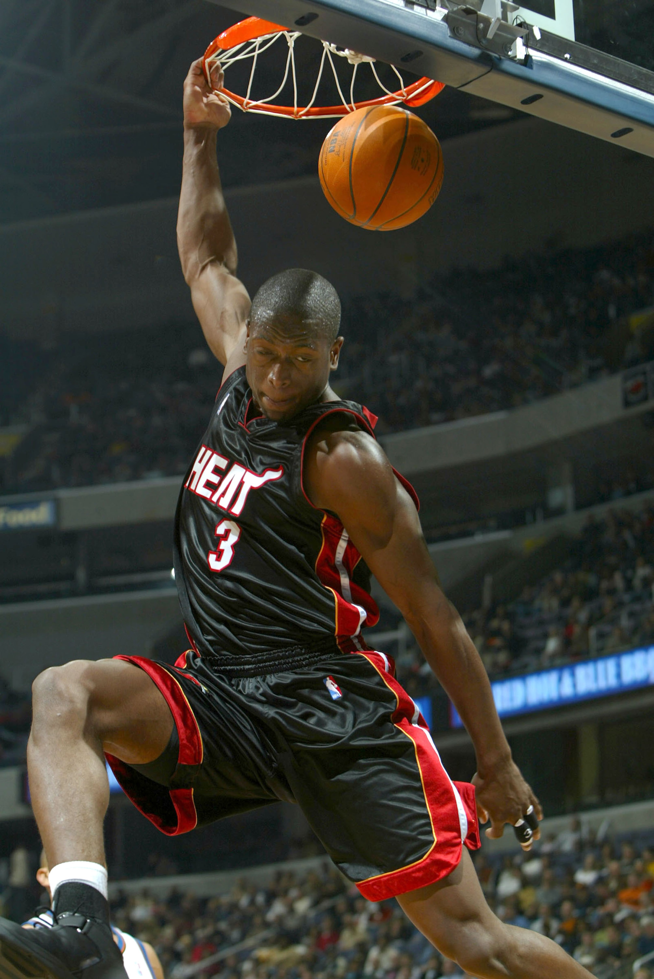 WASHINGTON - DECEMBER 26:  Dwyane Wade #3 of the Miami Heat dunks against the Washington Wizards during NBA action December 26, 2003 at the MCI Center in Washington, DC.  NOTE TO USER: User expressly acknowledges and agrees that by downloading and/or usin