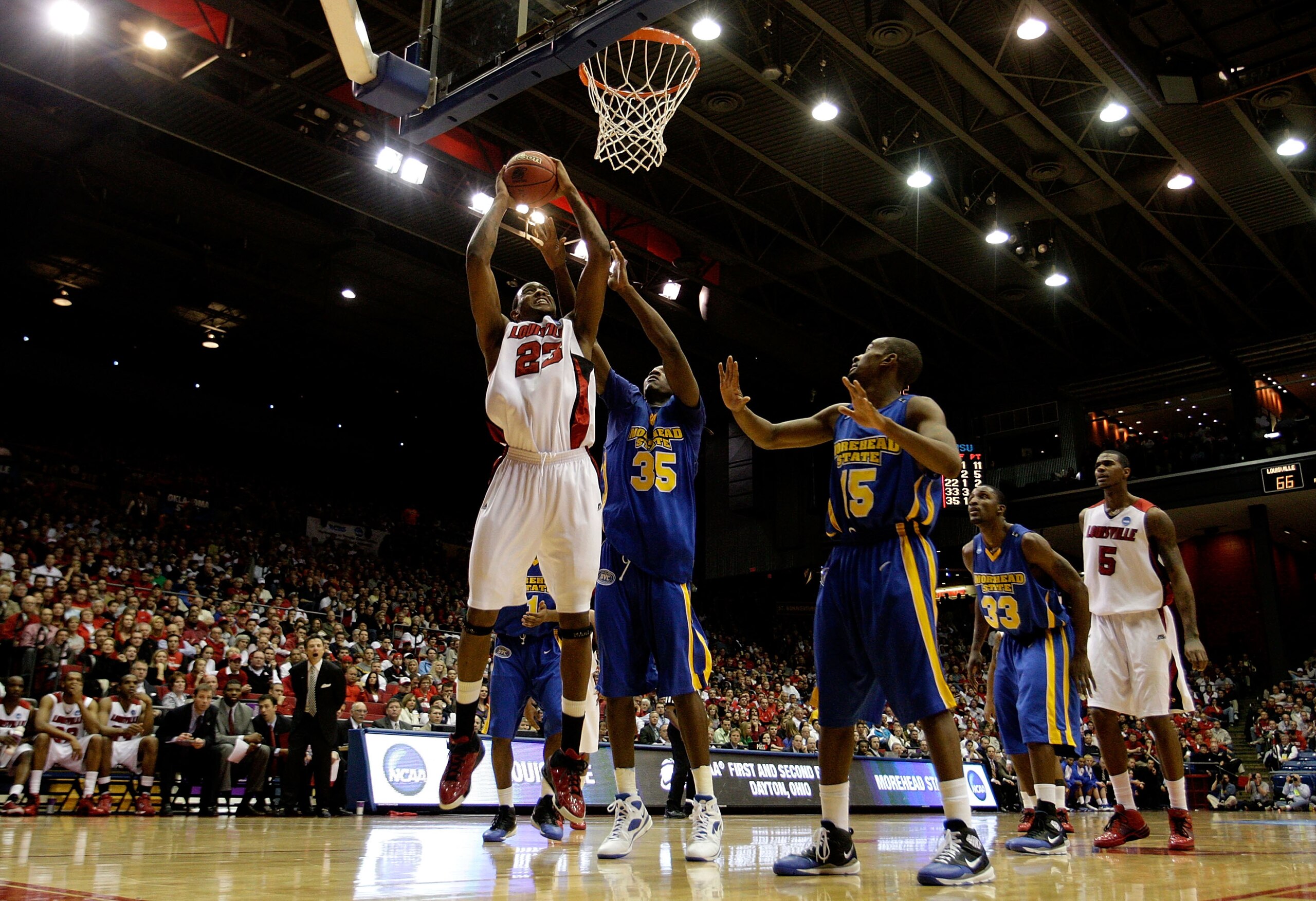 DAYTON, OH - MARCH 20: Terrence Jennings #23 of the Louisville Cardinals drives to the hoop against Kenneth Faried #35 of the Morehead State Eagles during the first round of the NCAA Division I Men's Basketball Tournament at the University of Dayton Arena