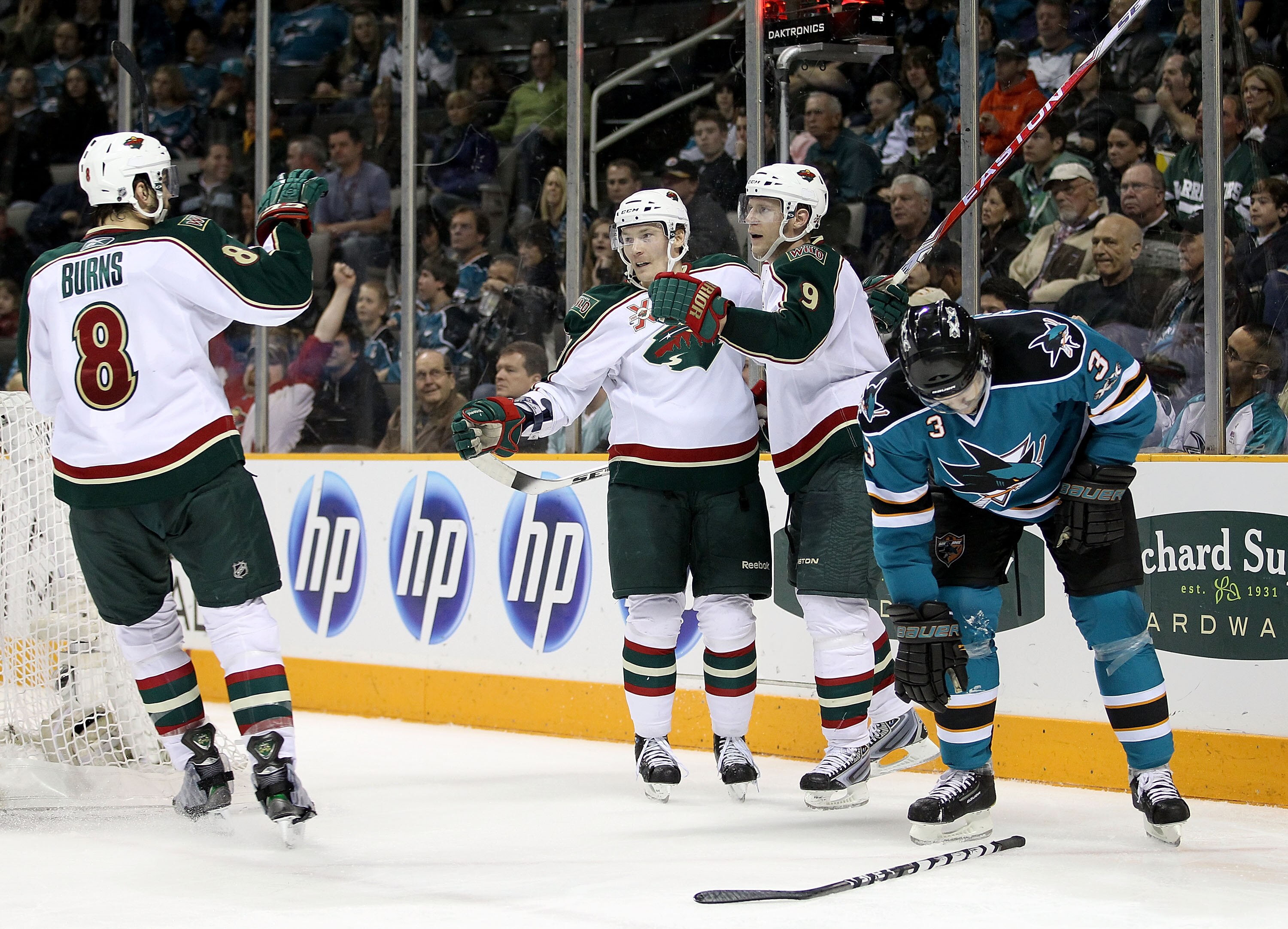 SAN JOSE, CA - JANUARY 22: Mikko Koivu #9 of the Minnesota Wild is congratulated by Antti Miettinen #20 and Brent Burns #8 after he scored his second goal of the night against the San Jose Sharks at HP Pavilion on January 22, 2011 in San Jose, California.