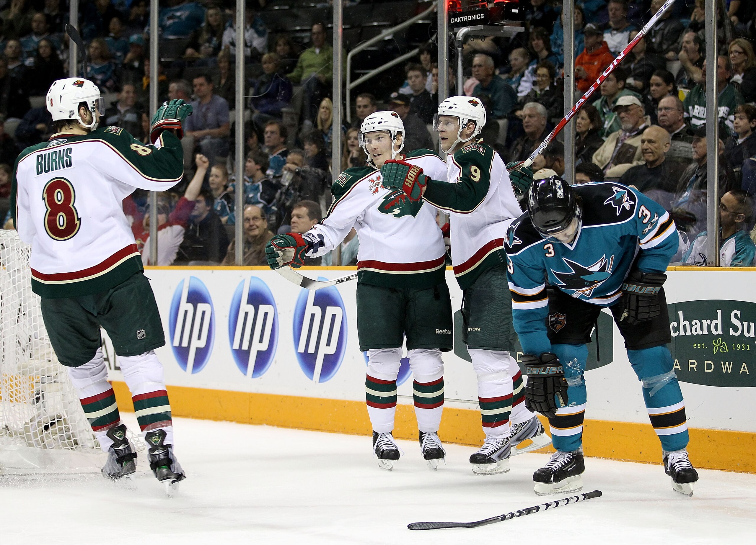 SAN JOSE, CA - JANUARY 22: Mikko Koivu #9 of the Minnesota Wild is congratulated by Antti Miettinen #20 and Brent Burns #8 after he scored his second goal of the night against the San Jose Sharks at HP Pavilion on January 22, 2011 in San Jose, California.