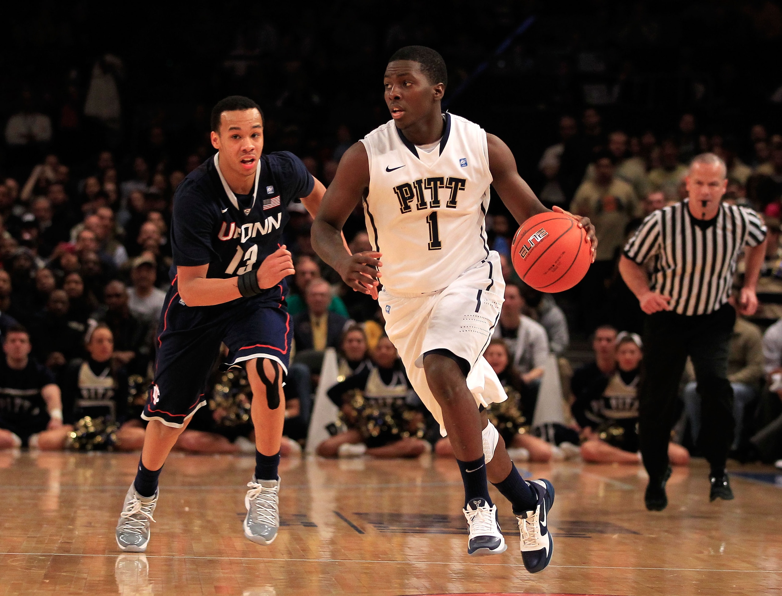 NEW YORK, NY - MARCH 10: Travon Woodall #1 of the Pittsburgh Panthers dribbles past Shabazz Napier #13 of the Connecticut Huskies during the quarterfinals of the 2011 Big East Men's Basketball Tournament presented by American Eagle Outfitters  at Madison