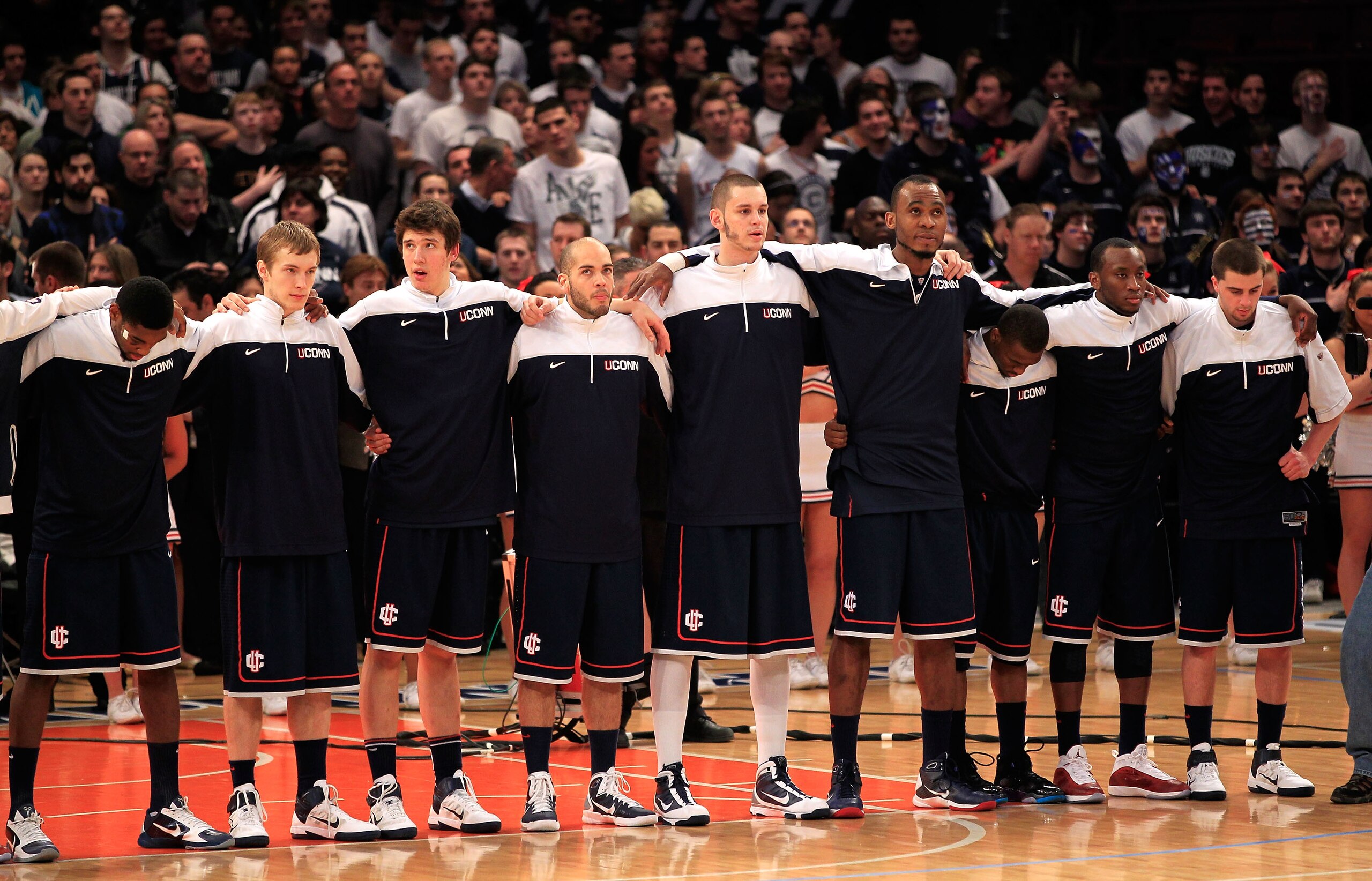 NEW YORK, NY - MARCH 12: The Connecticut Huskies look on during the National Anthem before their game against the Louisville Cardinals during the championship of the 2011 Big East Men's Basketball Tournament presented by American Eagle Outfitters at Madis