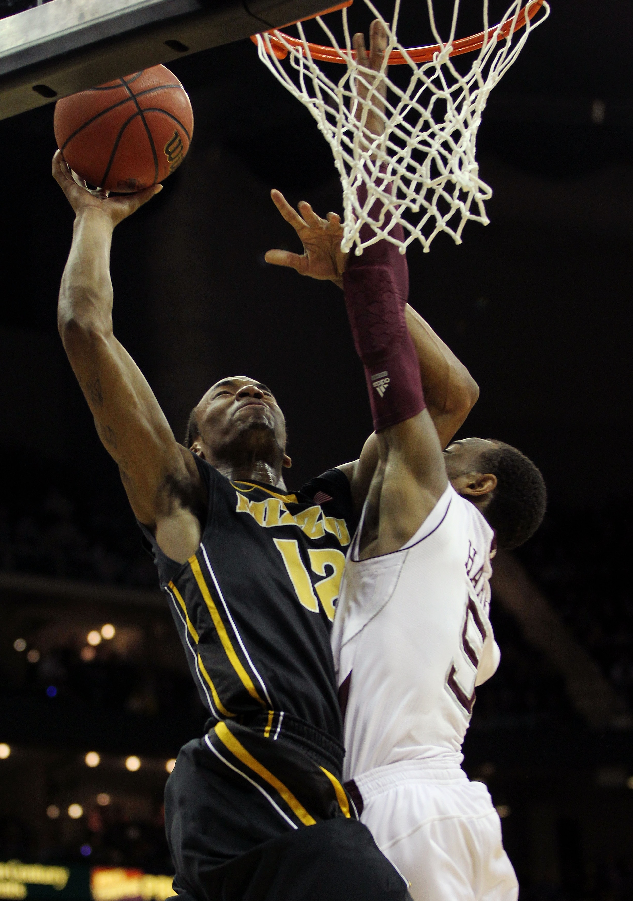 KANSAS CITY, MO - MARCH 10:  Marcus Denmon #12 of the Missouri Tigers goes up for a shot against Dash Harris #5 of the Texas A&M Aggies during their quarterfinal game in the 2011 Phillips 66 Big 12 Men's Basketball Tournament at Sprint Center on March 10,