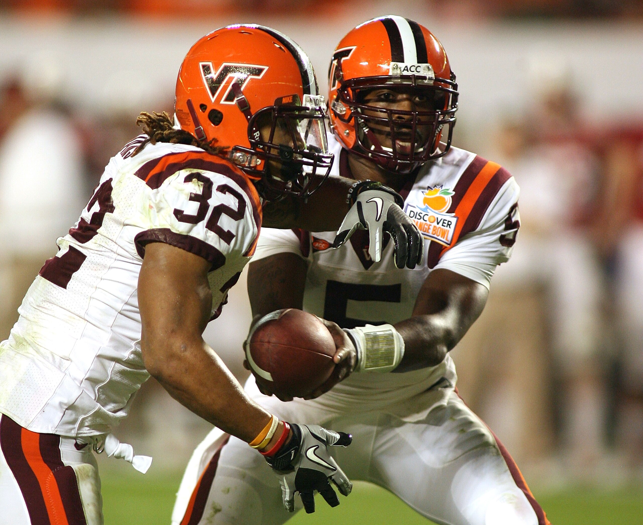 MIAMI, FL - JANUARY 03:  Tyrod Taylor #5 of the Virginia Tech Hokies hands the ball off to Darren Evans #32 against the Stanford Cardinal during the 2011 Discover Orange Bowl at Sun Life Stadium on January 3, 2011 in Miami, Florida. Stanford won 40-12.  (